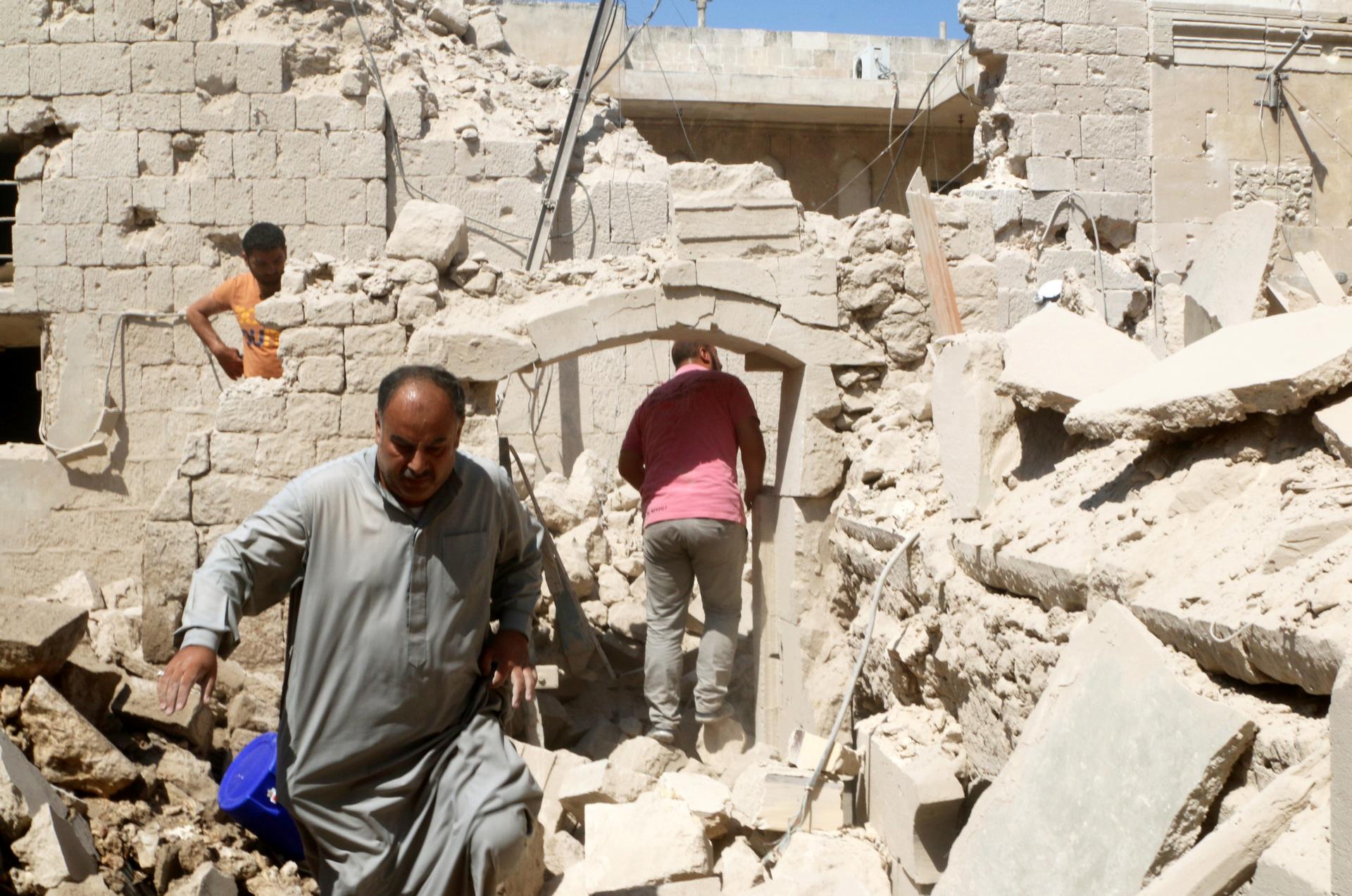 Residents inspect their damaged homes after an airstrike on the rebel-held Old Aleppo, Syria on Aug. 15.