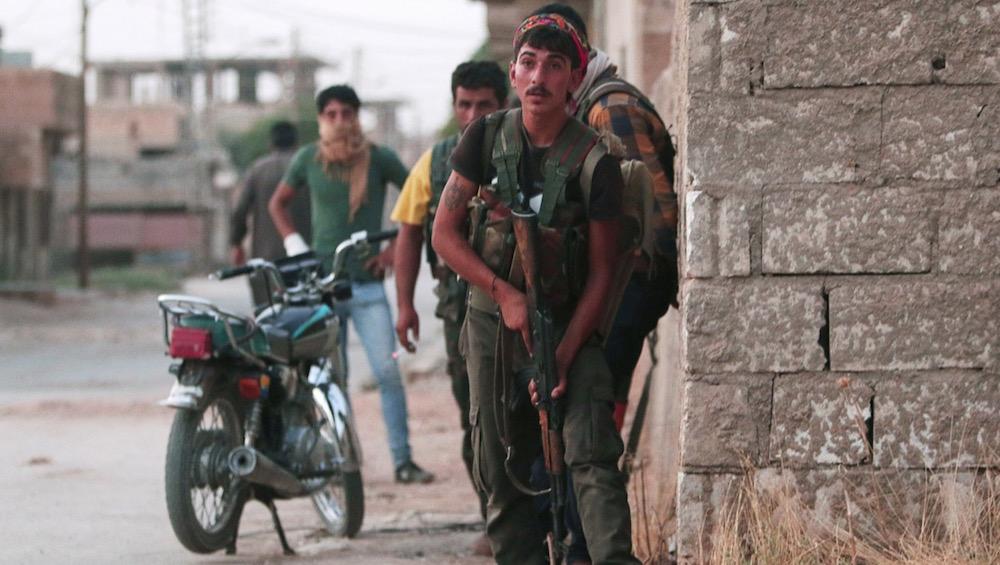 Kurdish YPG fighters take positions in the northeastern Syrian city of Hasaka, on Aug. 20.