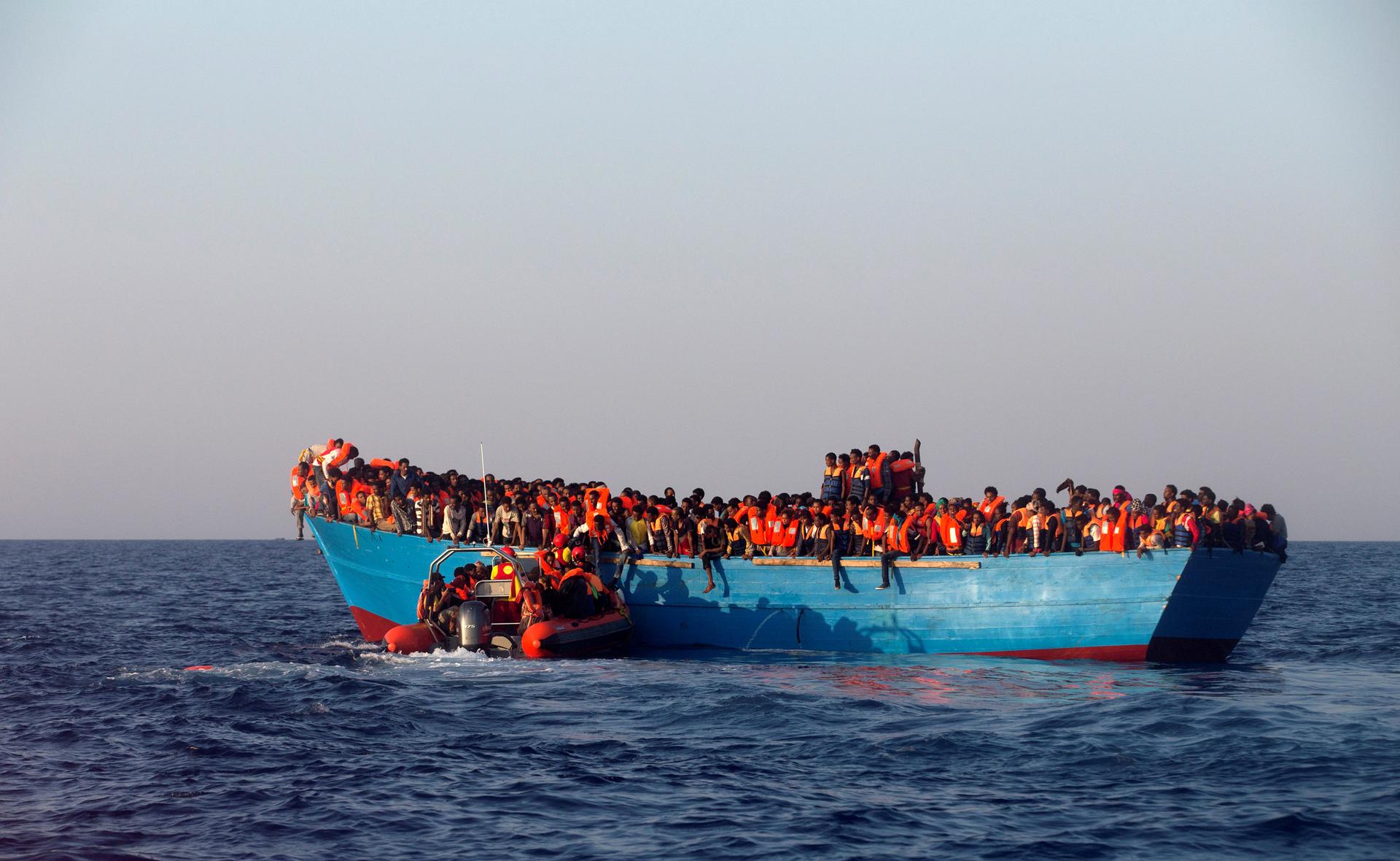 A rescue boat of the Spanish NGO Proactiva approaches an overcrowded wooden vessel with migrants from Eritrea, off the Libyan coast in Mediterranean Sea August 29, 2016. REUTERS/Giorgos Moutafis