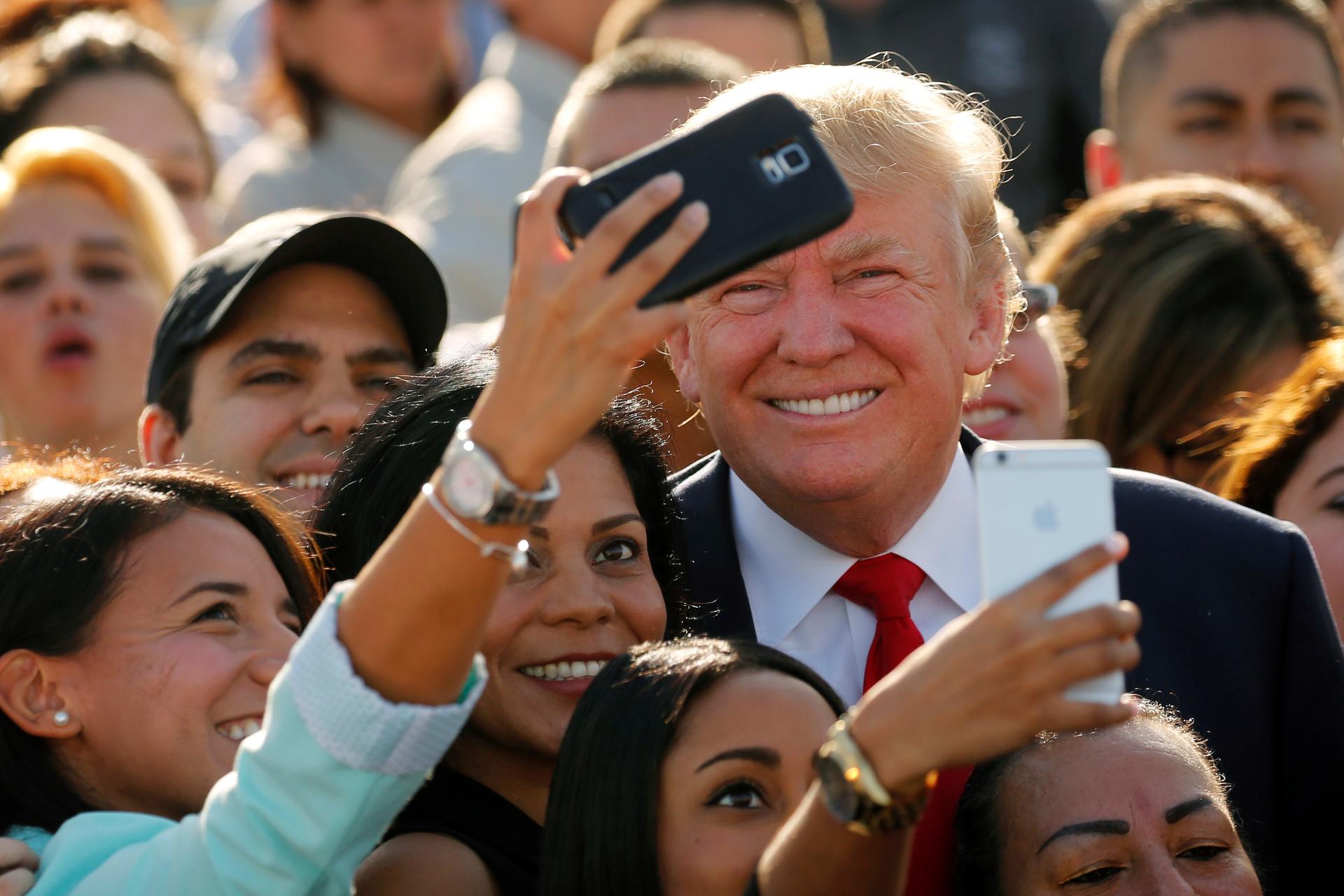 Trump poses for selfies in Miami, Florida, on October 25, 2016. 
