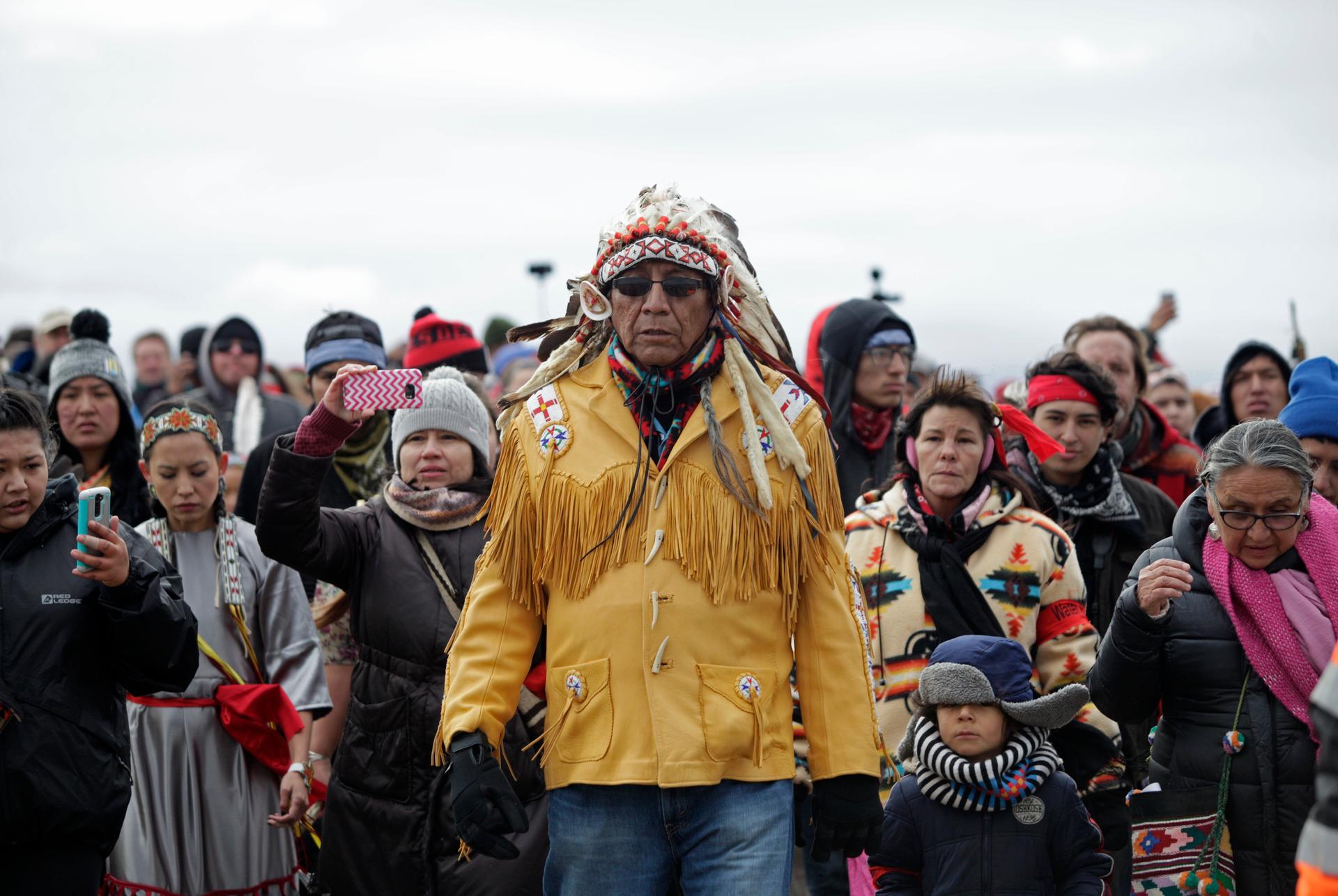 Chief Arvol Looking Horse, spiritual leader of the Sioux Nation, leads his people to peacefully pray near a law enforcement barricade just outside of a Dakota Access pipeline construction site north of Cannon Ball, North Dakota, on Oct. 29, 2016.