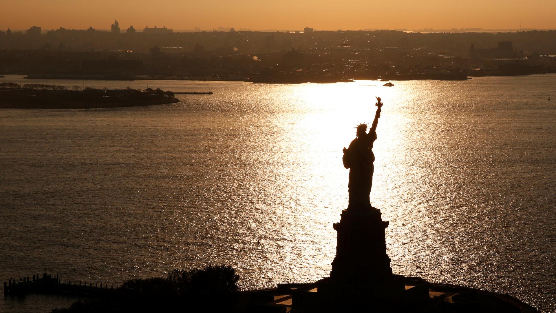 The sun rises on the Statue of Liberty, in New York, November 2nd 2016