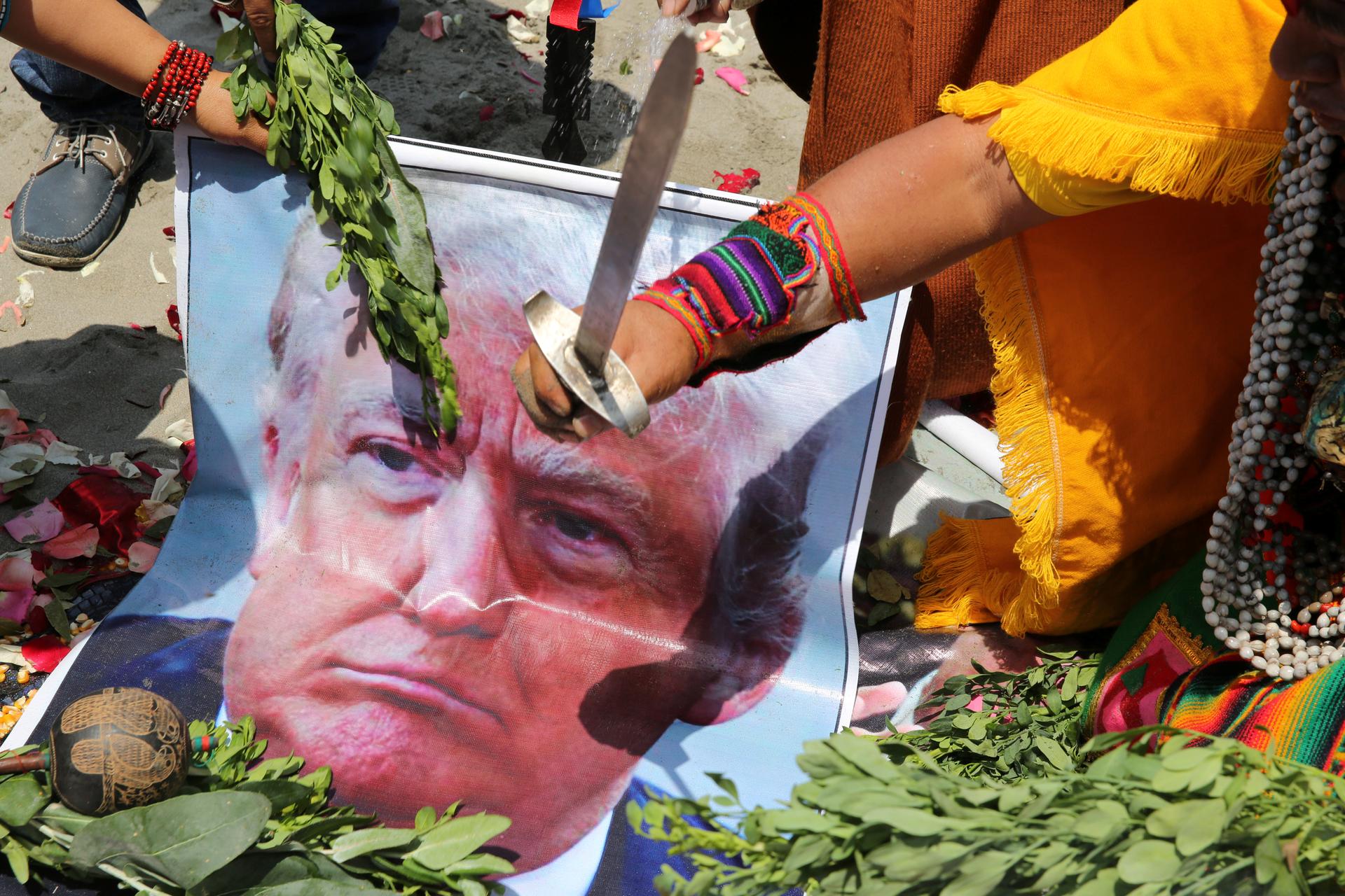 Peruvian shamans with poster of US Republican presidential candidate Donald Trump perform a ritual of predictions ahead of the US presidential elections, in Lima, Peru November 7, 2016.