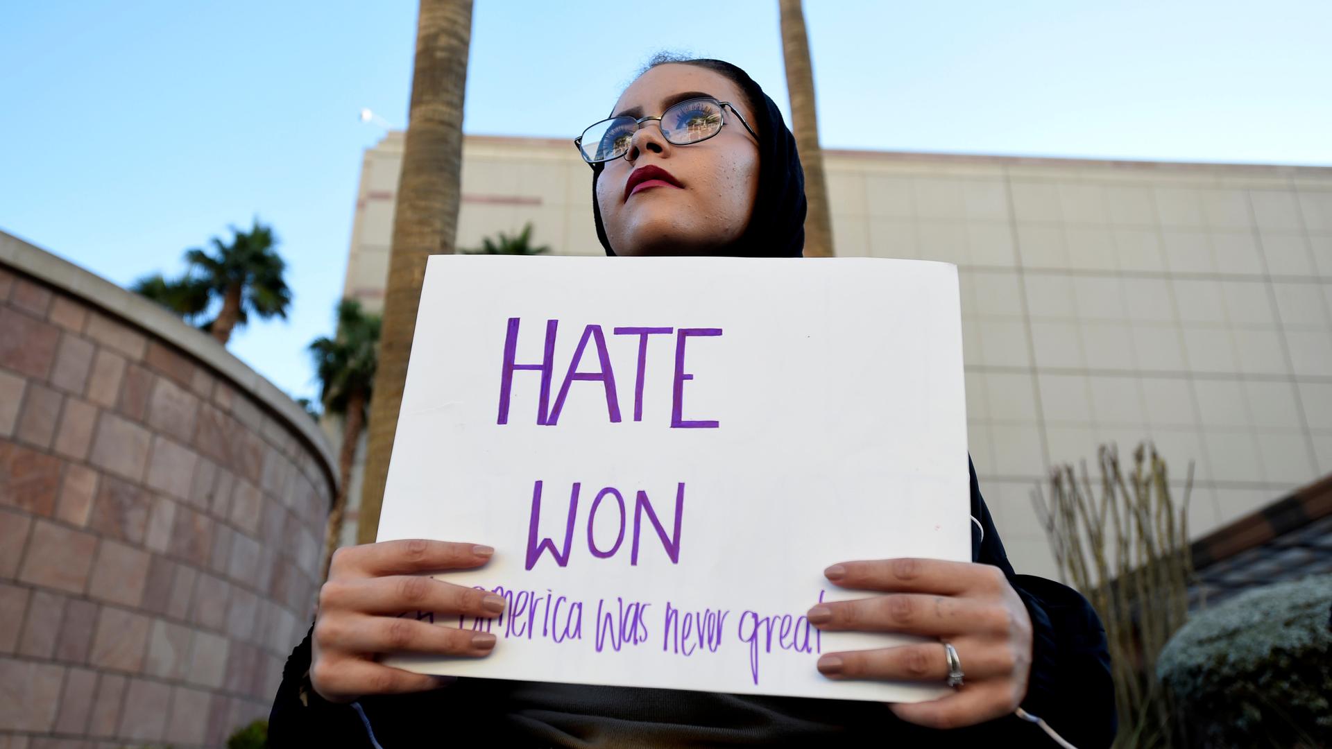 Krystina Robinson of Las Vegas carries a placard in protest against the election of Donald Trump, near the Trump Hotel and Tower in Las Vegas.