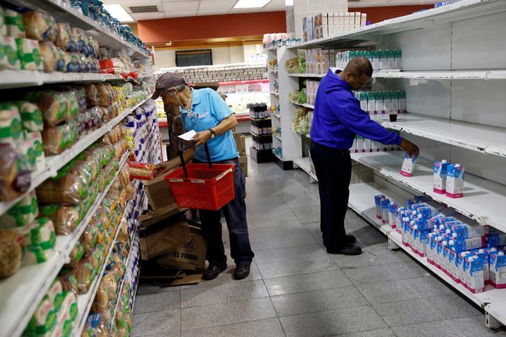 People look for groceries and goods at a supermarket in Caracas, Venezuela November 11, 2016. 