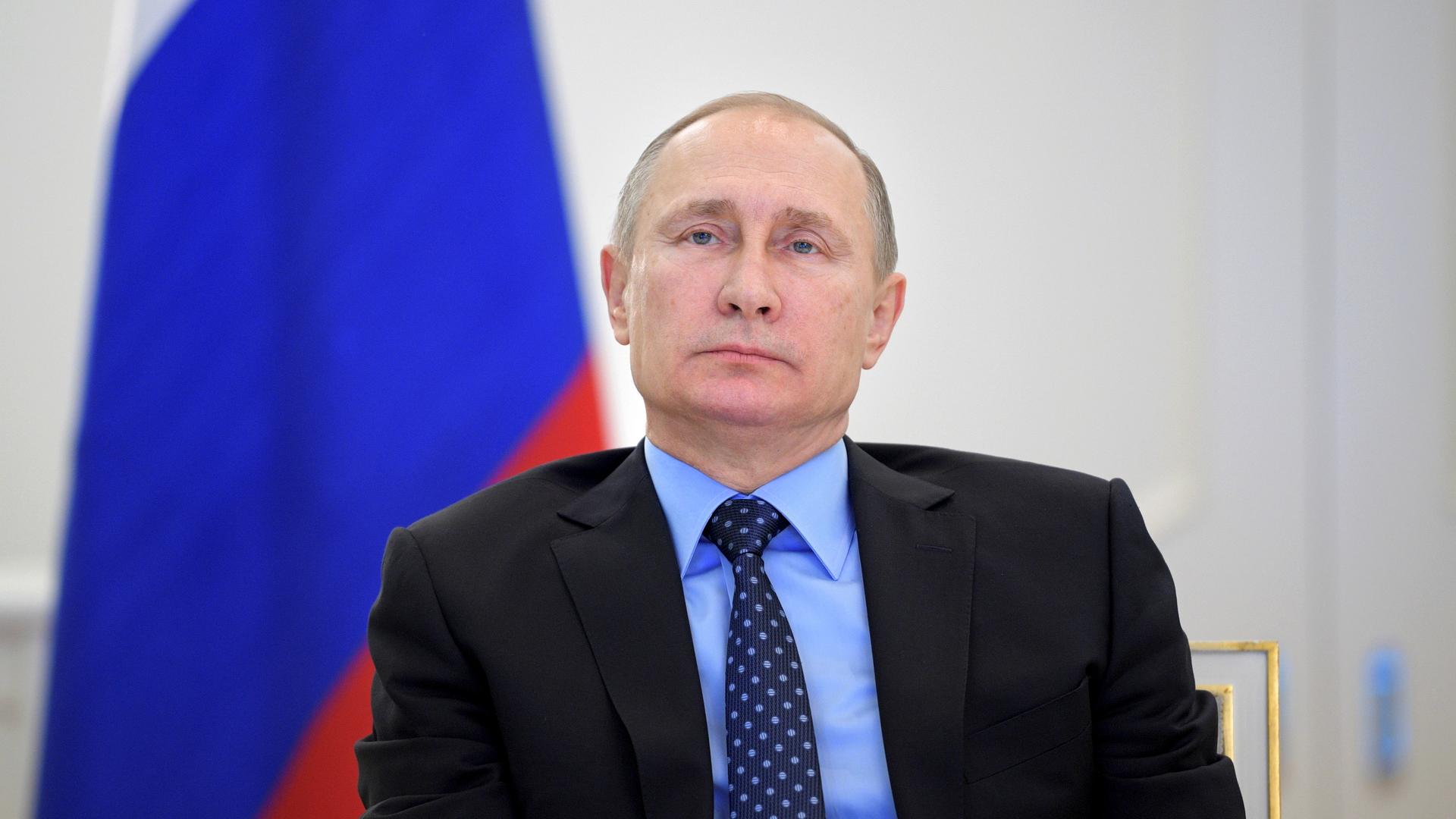 Russian President Vladimir Putin, seen here at a public event on Tuesday, is not reacting to new US sanctions