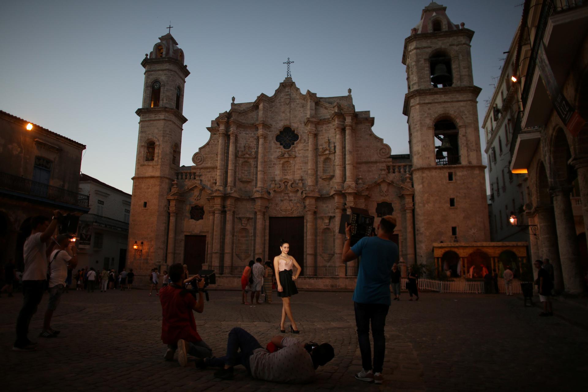 Yazuli Lloret, 15, poses for a photographer at the Cathedral Square in Havana, Cuba, December 27, 2016.