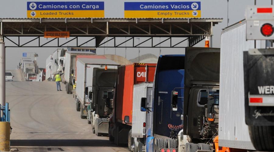Trucks wait in a long line for border customs control to cross into the US at the Otay border crossing in Tijuana, Mexico.