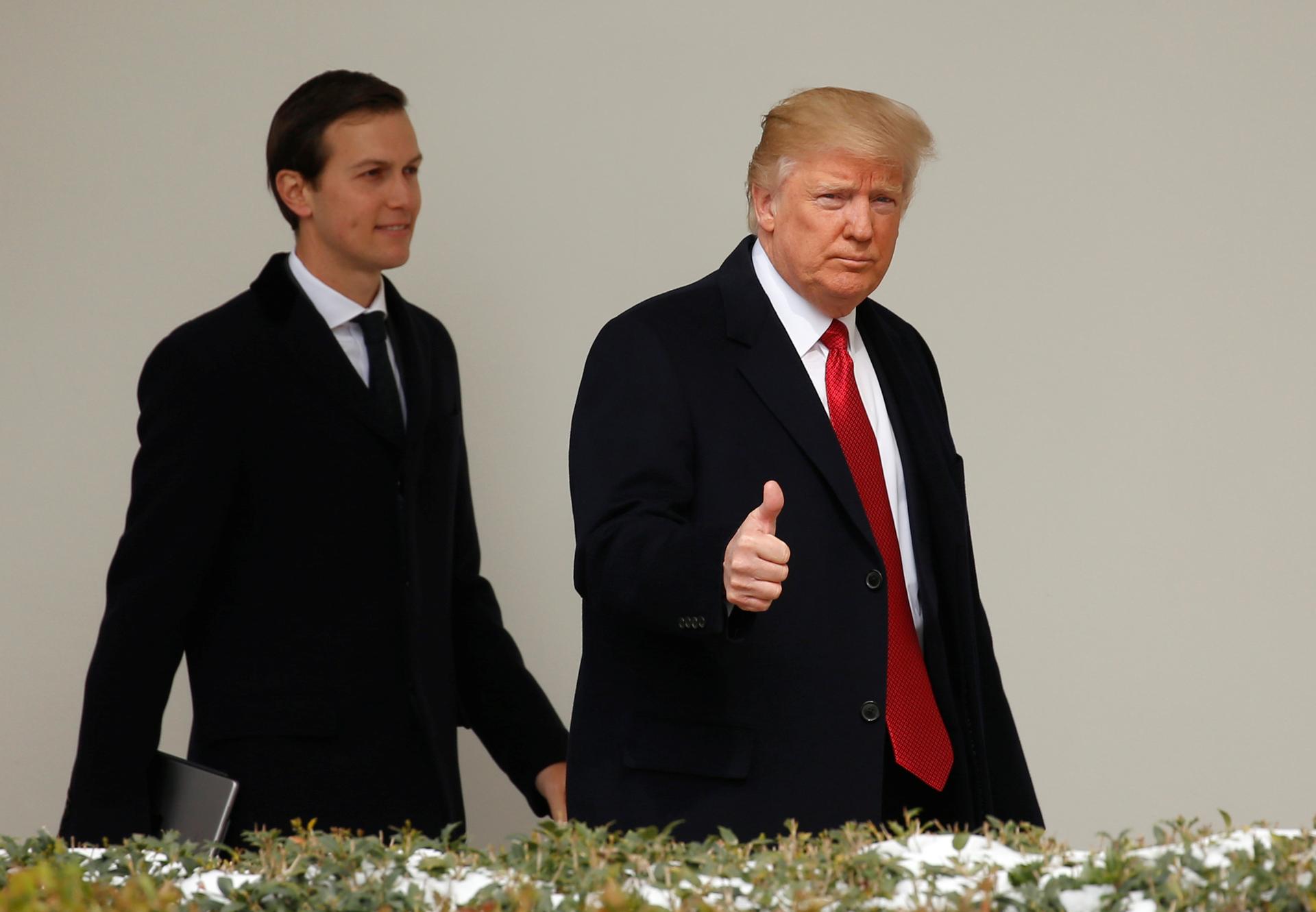 Two men walk outside the White House