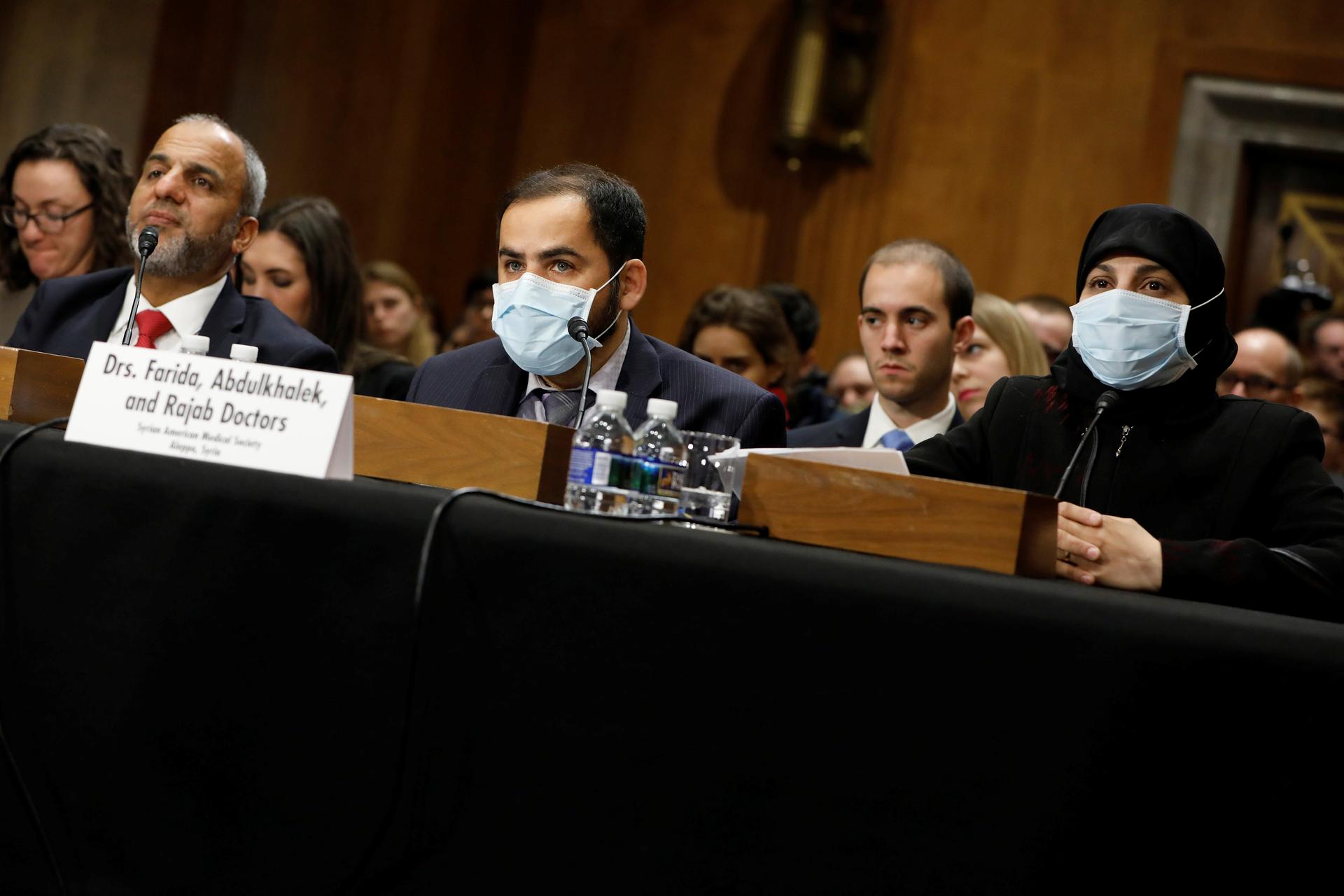 Drs. Abdulkhalek (center) and Farida (right)  look on during a Senate Foreign Relations hearing on the conflict in Syria on Capitol Hill in Washington.