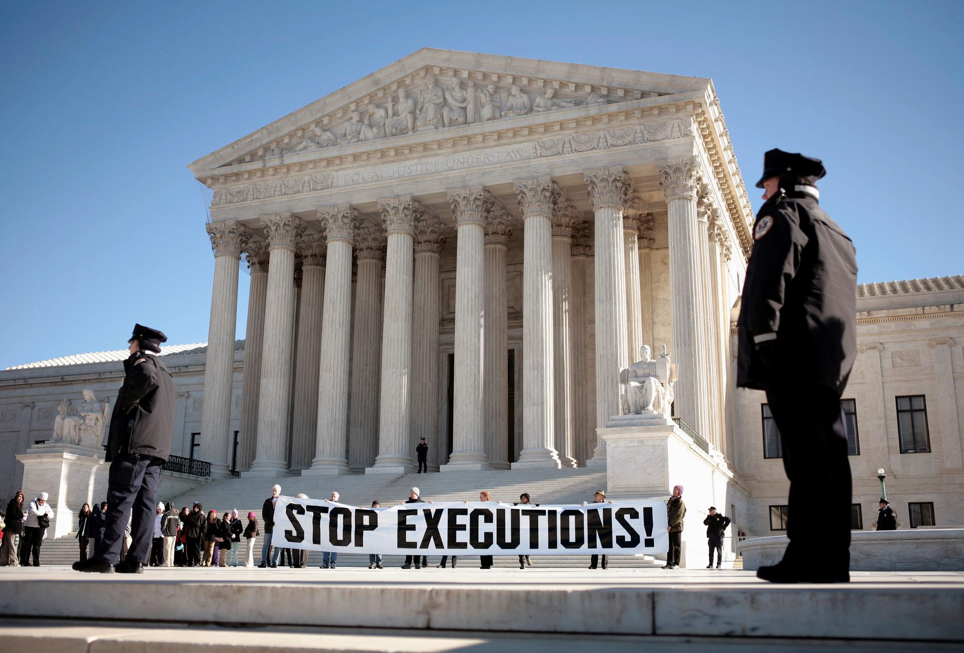A panel protesting the death penalty is unfurled at the supreme court