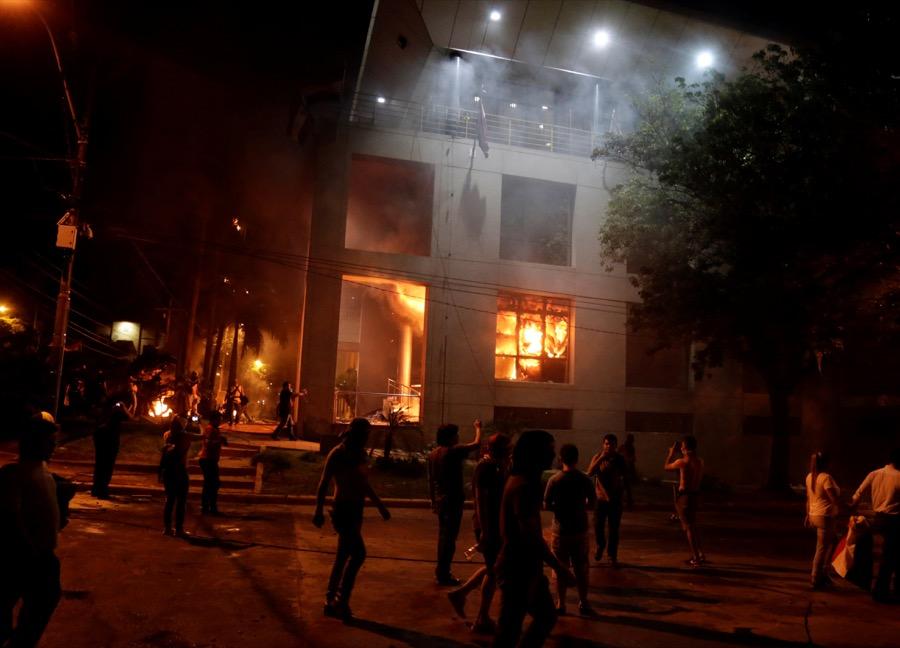 Protesters set fire to the congress building during a demonstration against a possible change in the law to allow for presidential re-election in Asunción, Paraguay on March 31.