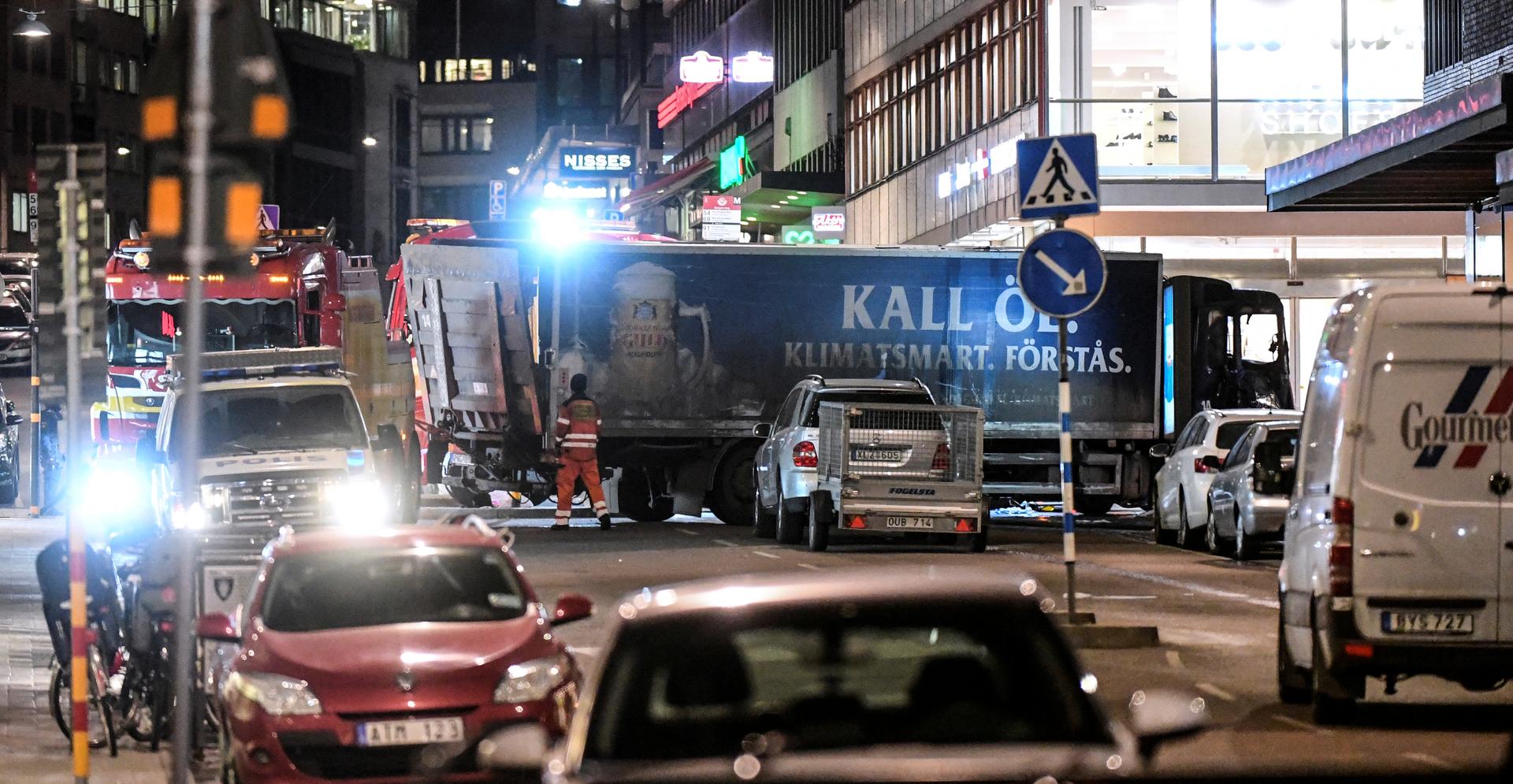 Tow trucks move the beer truck that crashed into the department store Ahlens after plowing down the Drottninggatan Street in central Stockholm, Sweden, April 7, 2017.