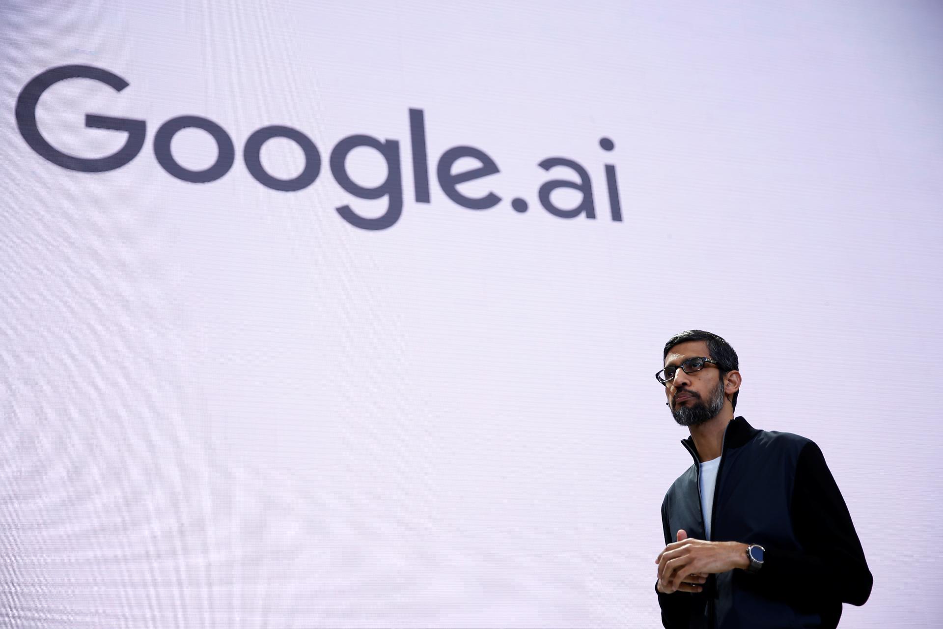 Google CEO Sundar Pichai stands on a stage