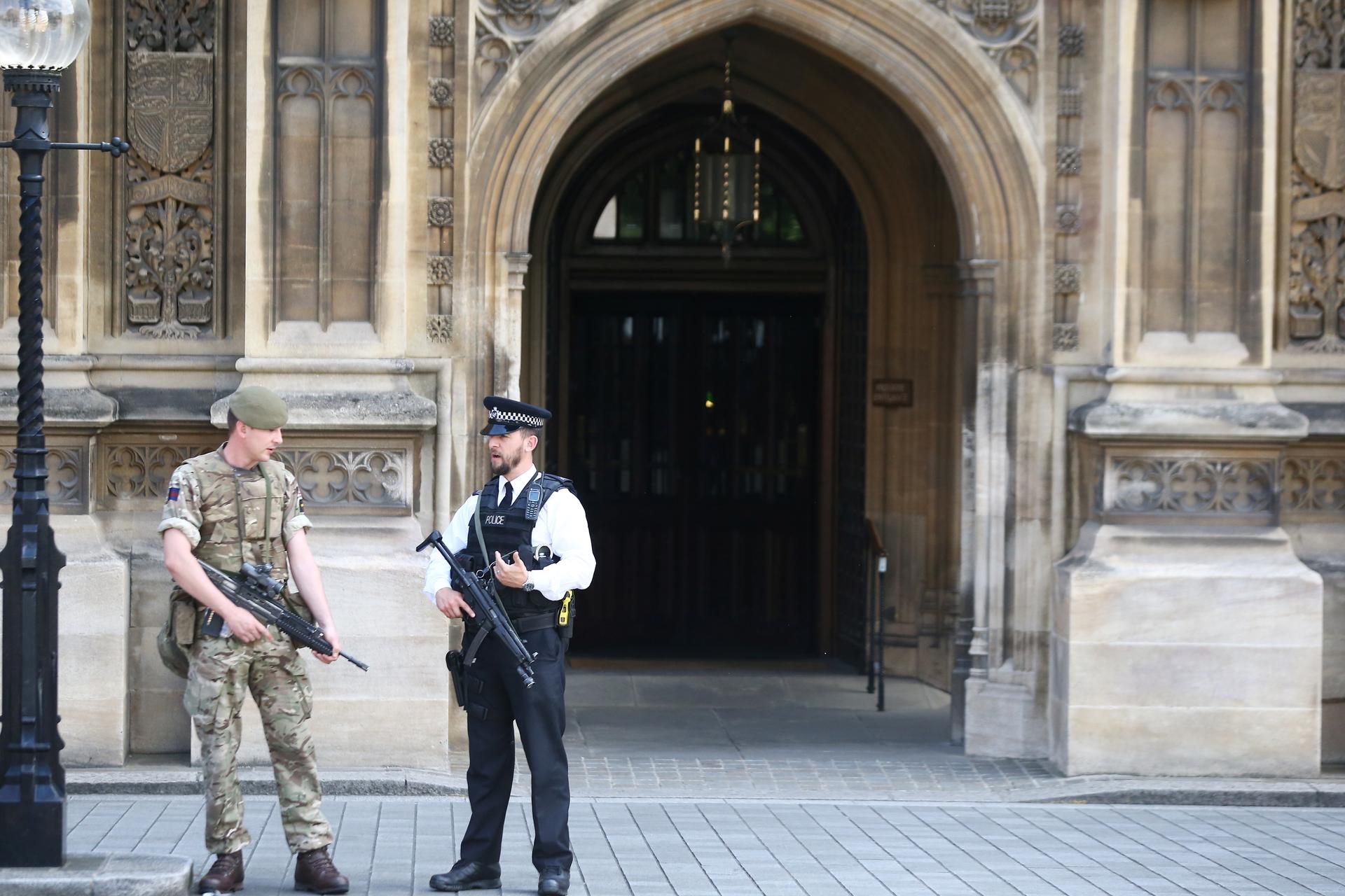 UK police and soldiers patrol outside the UK parliament in London. Britain remains at a 'Critical' level of terror alert following the bomb attack on Monday. 