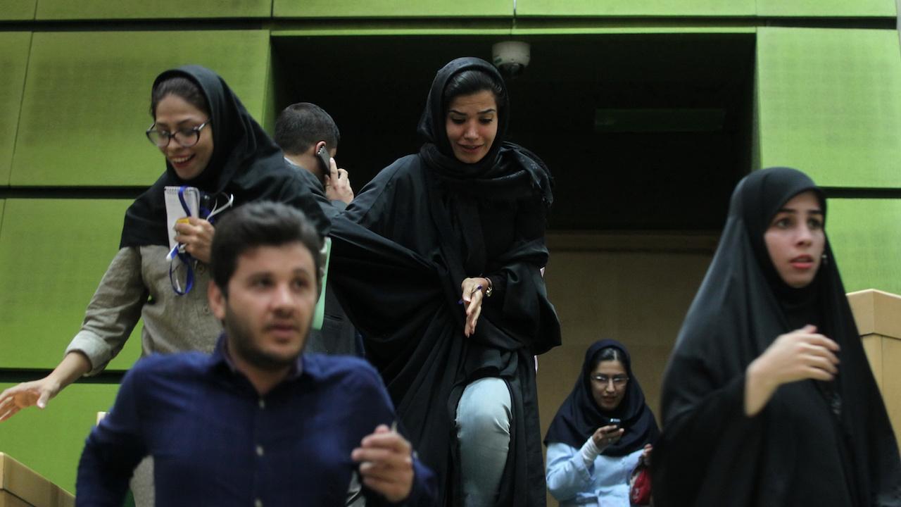 People are seen inside Iran's parliament during an attack in central Tehran
