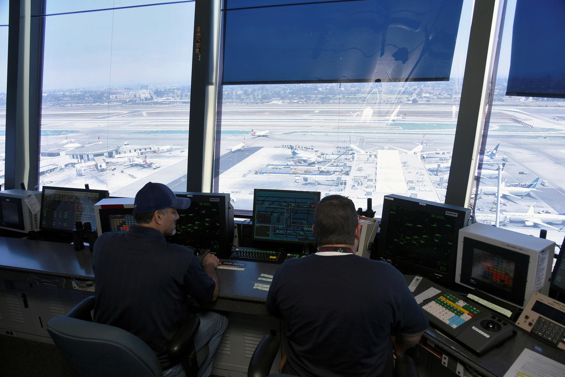 Air traffic controllers work inside the control tower at Los Angeles International Airport (LAX) in Los Angeles, California, U.S. on June 24, 2016.
