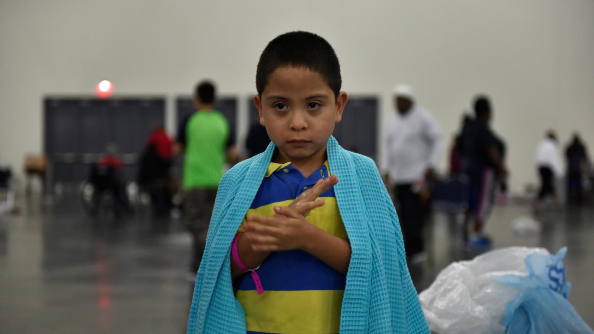 Evacuee Pete Quintana Jr. is wrapped in a blanket at the George R. Brown Convention Center after Hurricane Harvey in Houston, Texas, Aug. 28, 2017.