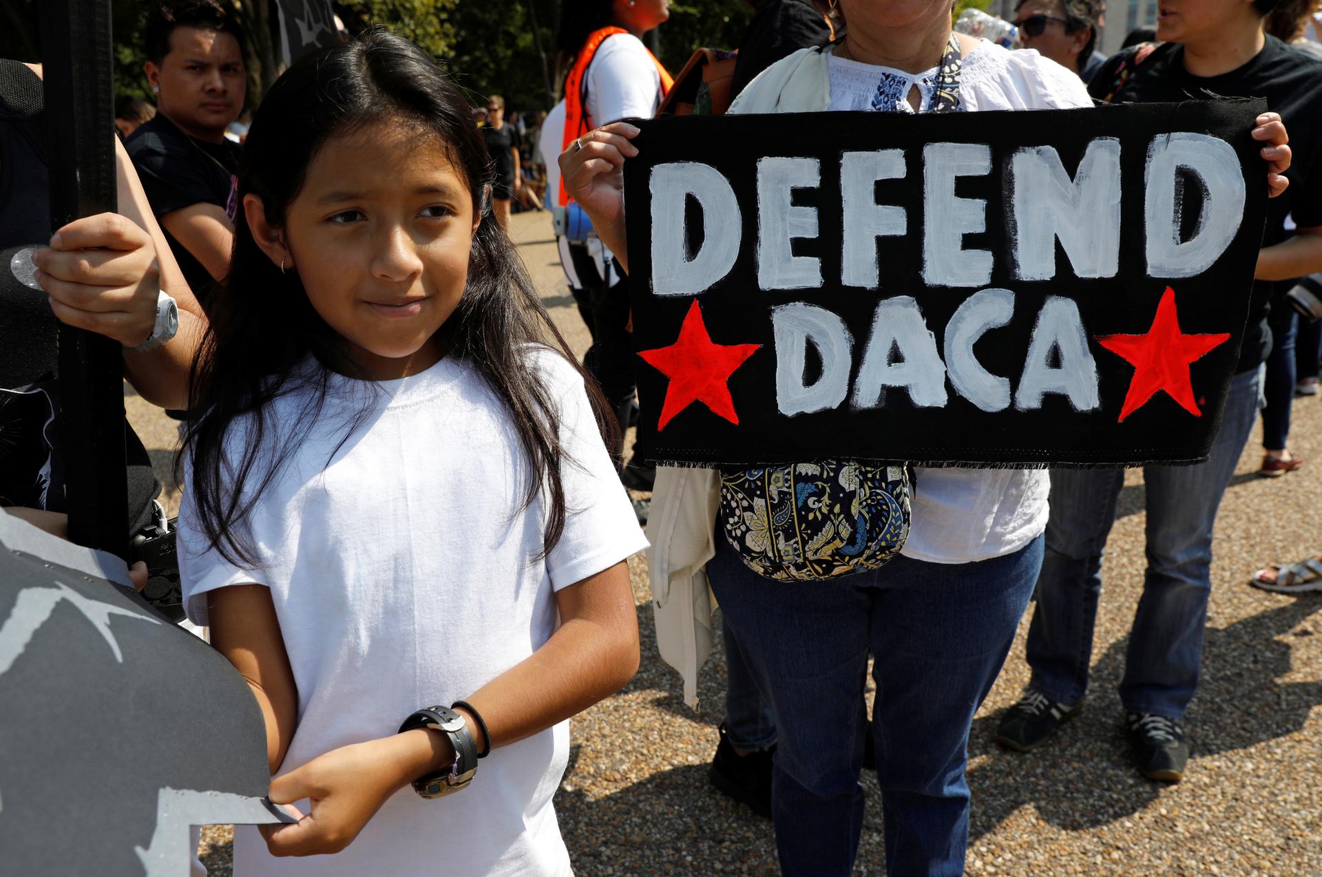 Demonstrators hold signs during a protest in front of the White House after the Trump administration on Tuesday scrapped the Deferred Action for Childhood Arrivals (DACA), a program that protects from deportation almost 800,000 young men and women who wer