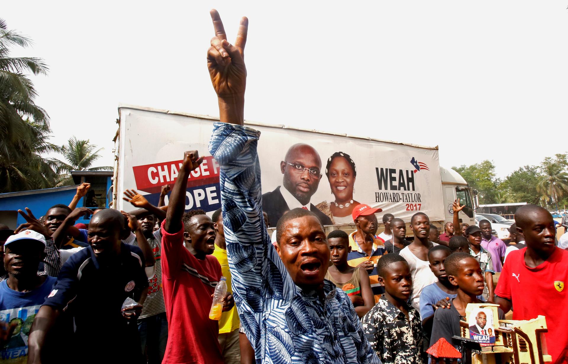Supporters of George Weah, former soccer player and presidential candidate of Coalition for Democratic Change (CDC), celebrate after the announcement of the presidential election results in Monrovia, Liberia