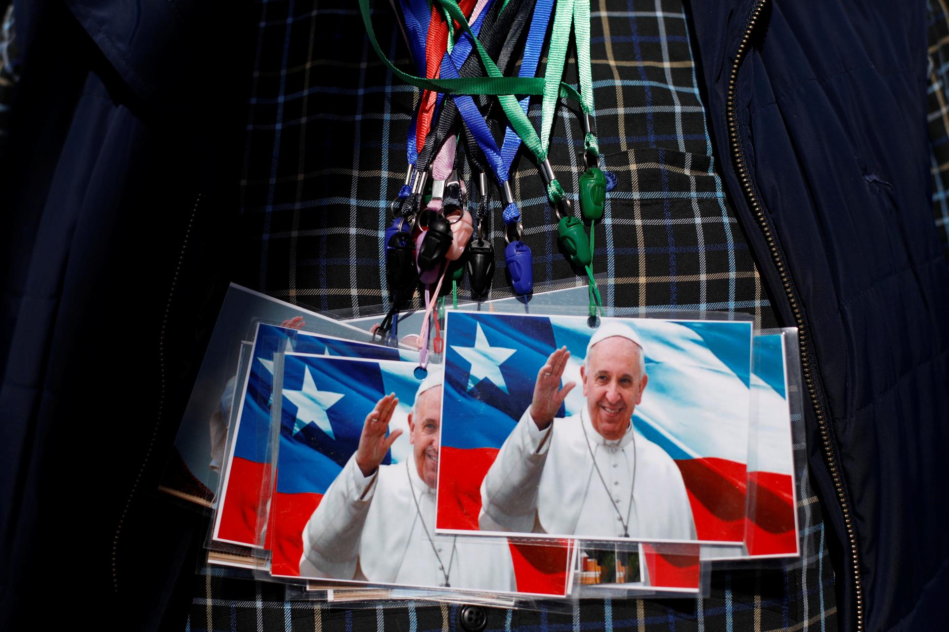 A man exhibits on his chest photos of Pope Francis to sell outside St. Jose Cathedral ahead of the papal visit in Temuco, Chile, Jan. 14, 2018.