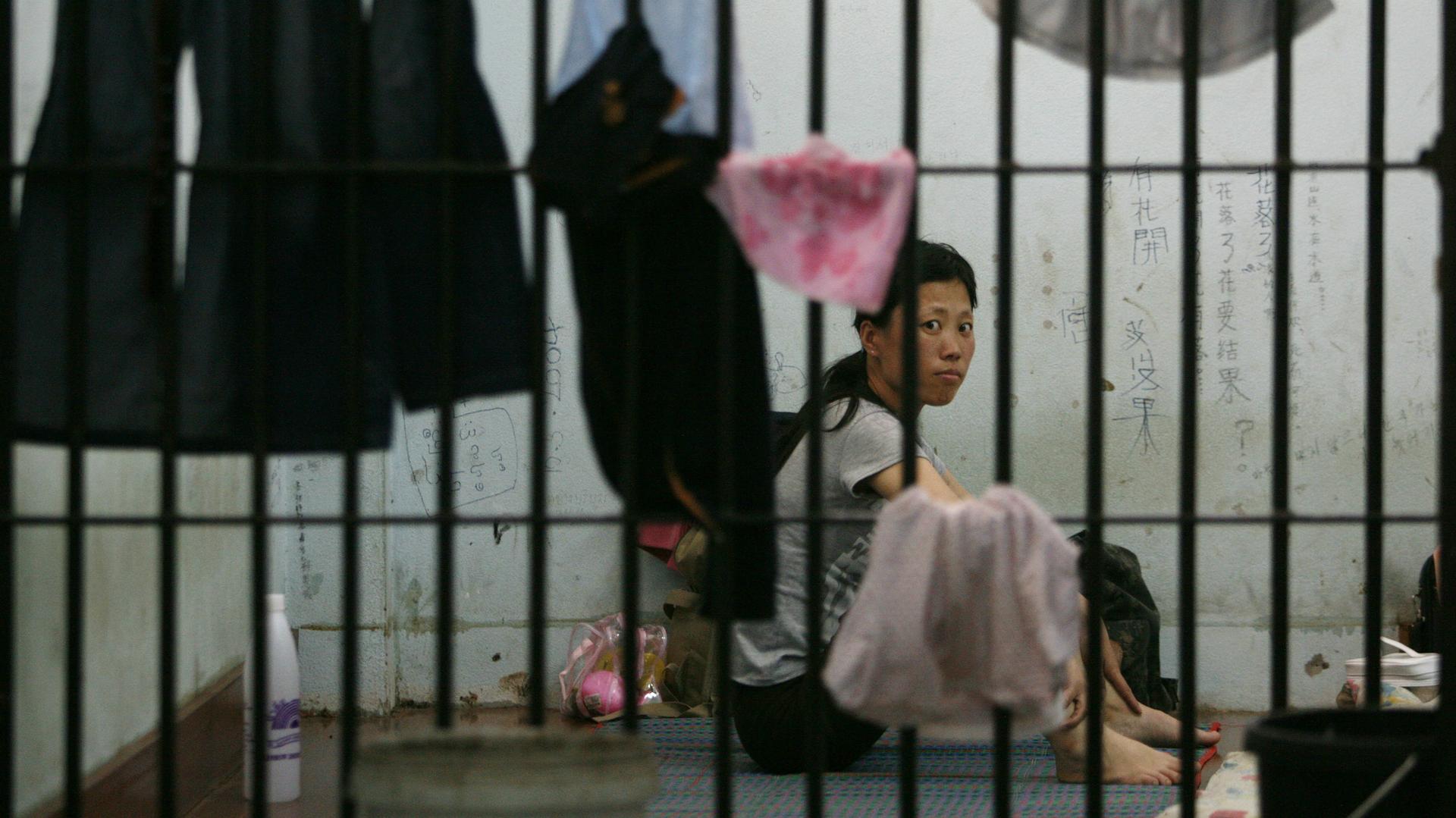 Cheong-Suk Ryang, 36, a defector from North Korea hoping to reach South Korea via Thailand, sits in her cell at the Chiang Saen police station in Thailand, after she and four other North Korean women were arrested on the Thai-Lao border. Photo taken May 9