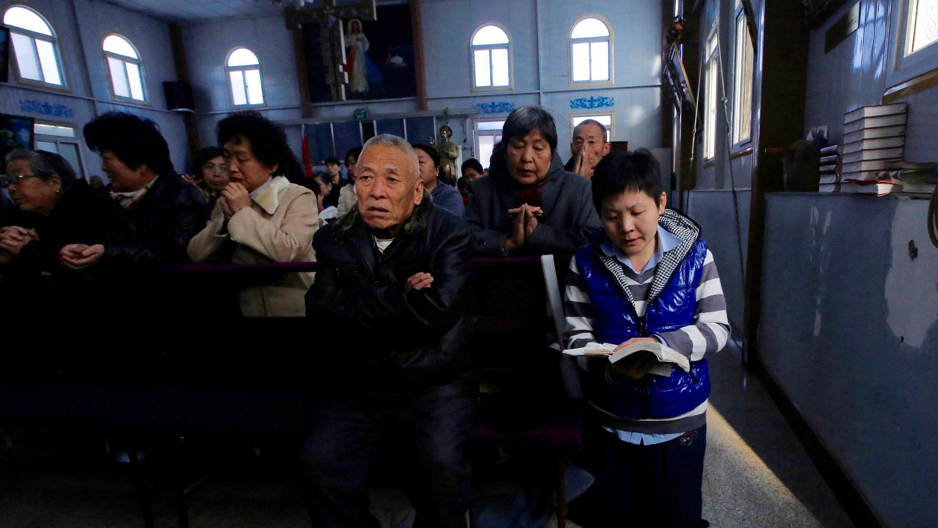 Believers take part in a weekend service at an underground Catholic church in the Chinese city of Tianjin on November 10, 2013.