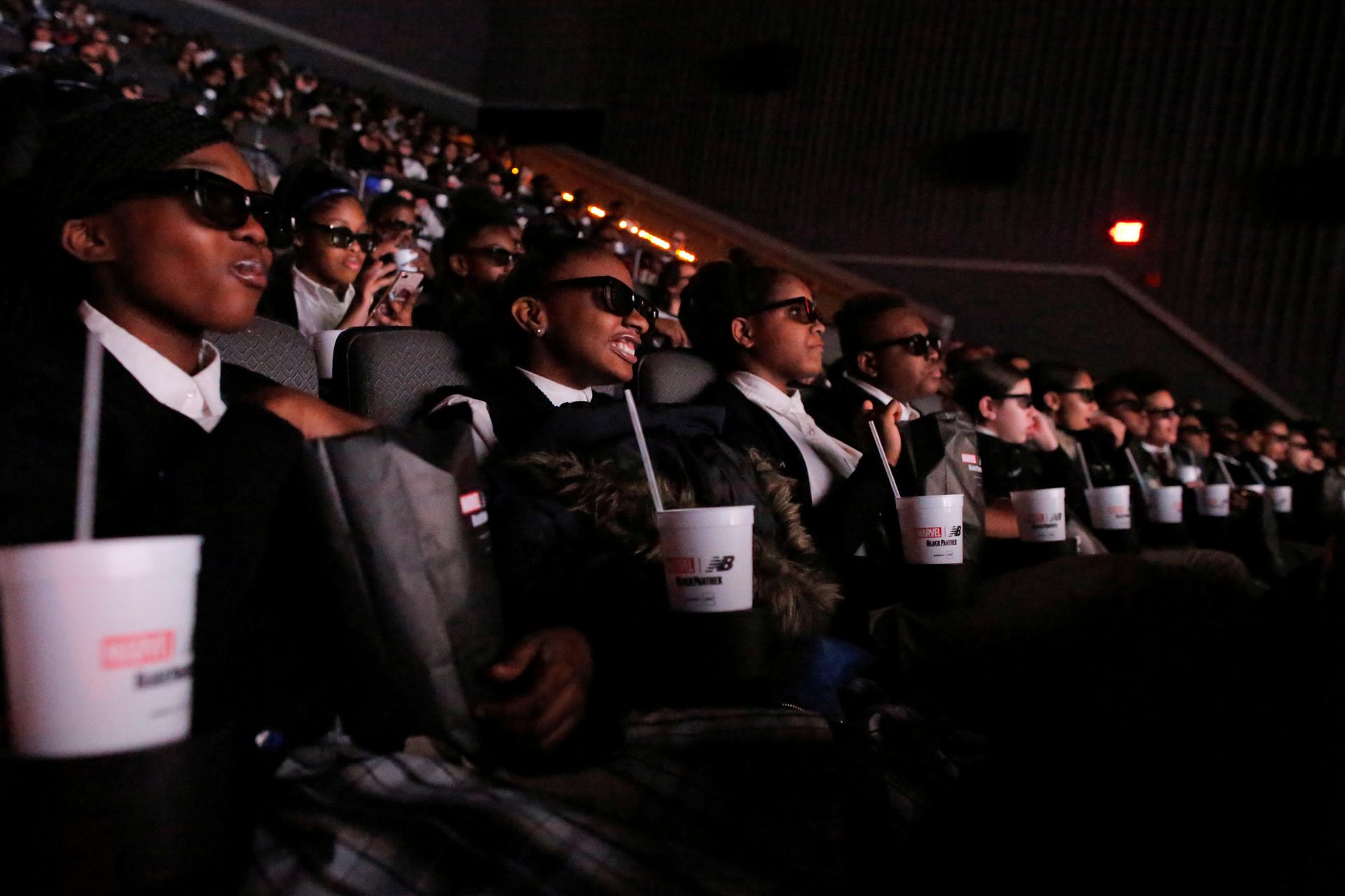 Students from the Capital Preparatory Harlem School watch a screening of the film "Black Panther" on its opening night.