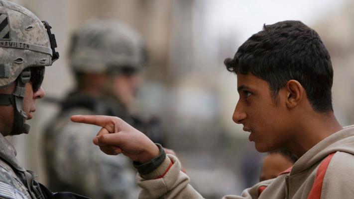 A resident gestures as he talks to a U.S. soldier from 2nd Brigade combat team, 82nd Airborne on patrol in Baghdad's Adhamiya district January 5, 2008.