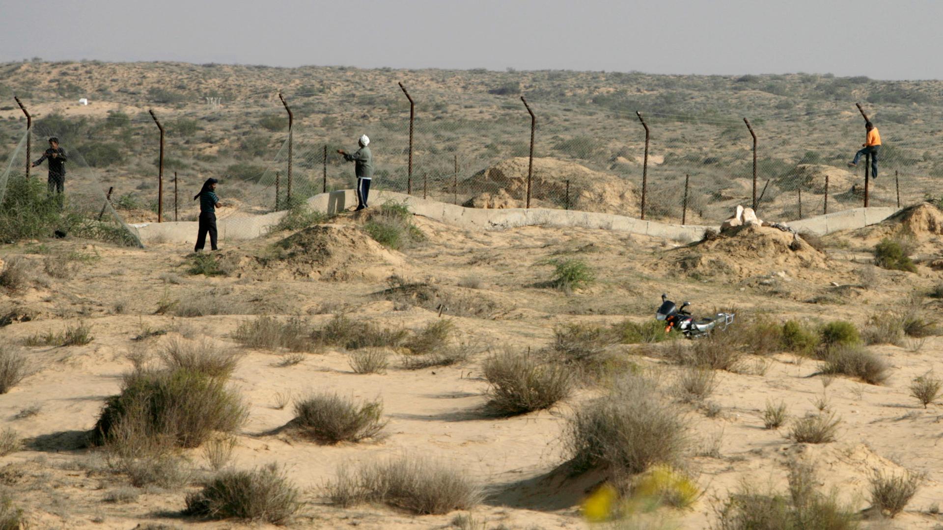 Bedouin loot barbed wire near a police checkpoint on the Egyptian border with Israel on the Sinai Peninsula.