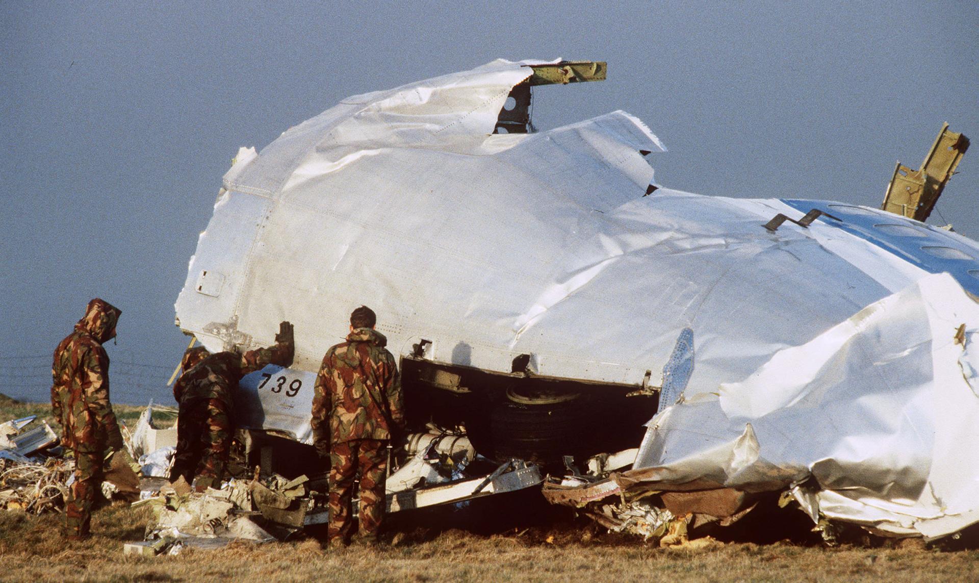 Crash investigators search the area around the cockpit of Pan Am flight 103 in a farmer's field east of Lockerbie Scotland after a mid-air bombing killed all 259 passengers and crew, and 11 people on the ground.