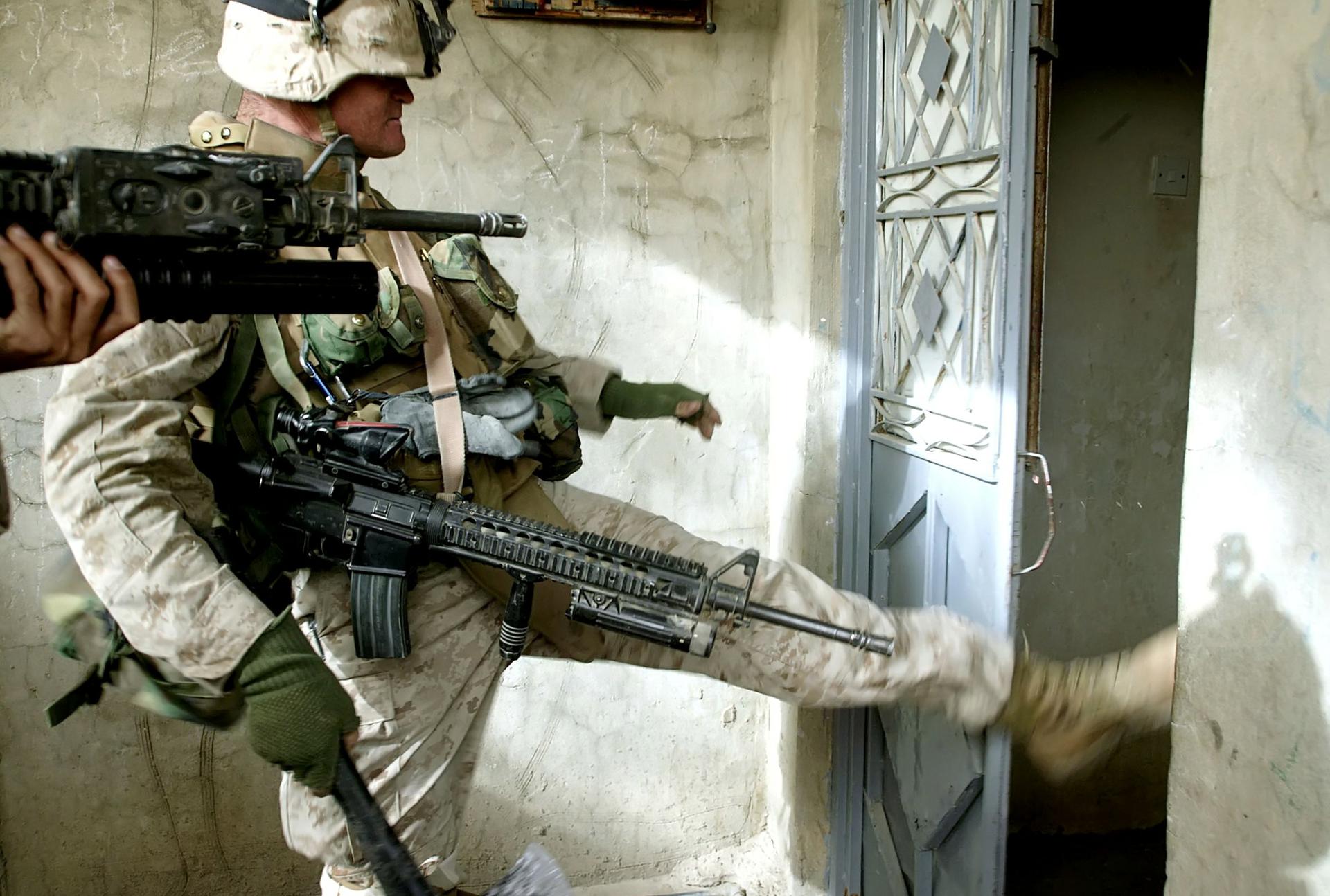 U.S. Marine Lance Corporal Michael Oliver Ray, on a search operation in Fallujah, Iraq in December 2004. An American offensive at the time came to be known as "The Second Battle of Fallujah." 