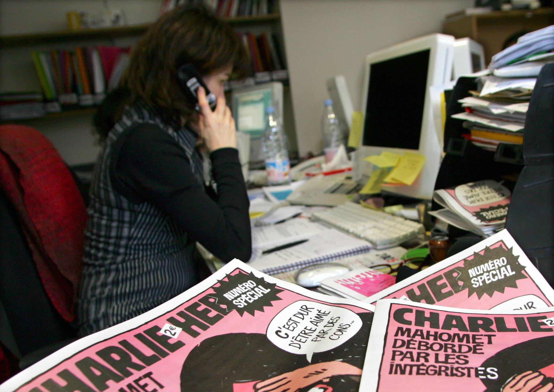 The copies of the French satirical weekly Charlie Hebdo seen in their Paris newsroom on February 9, 2006. In this and other issues, the magazine published cartoons that angered Muslims.