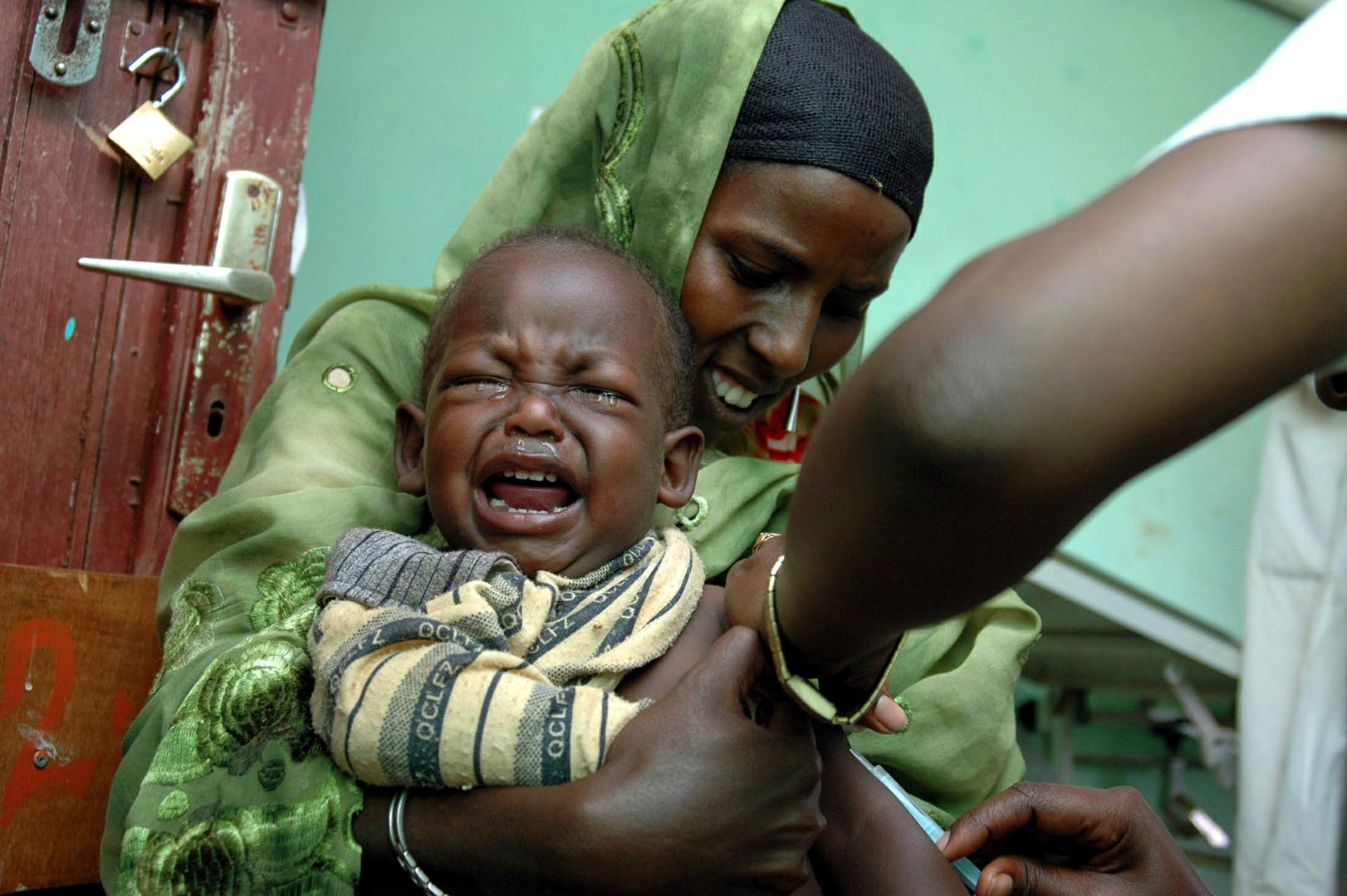 A young boy in Ethiopia cries as he gets a measles vaccination