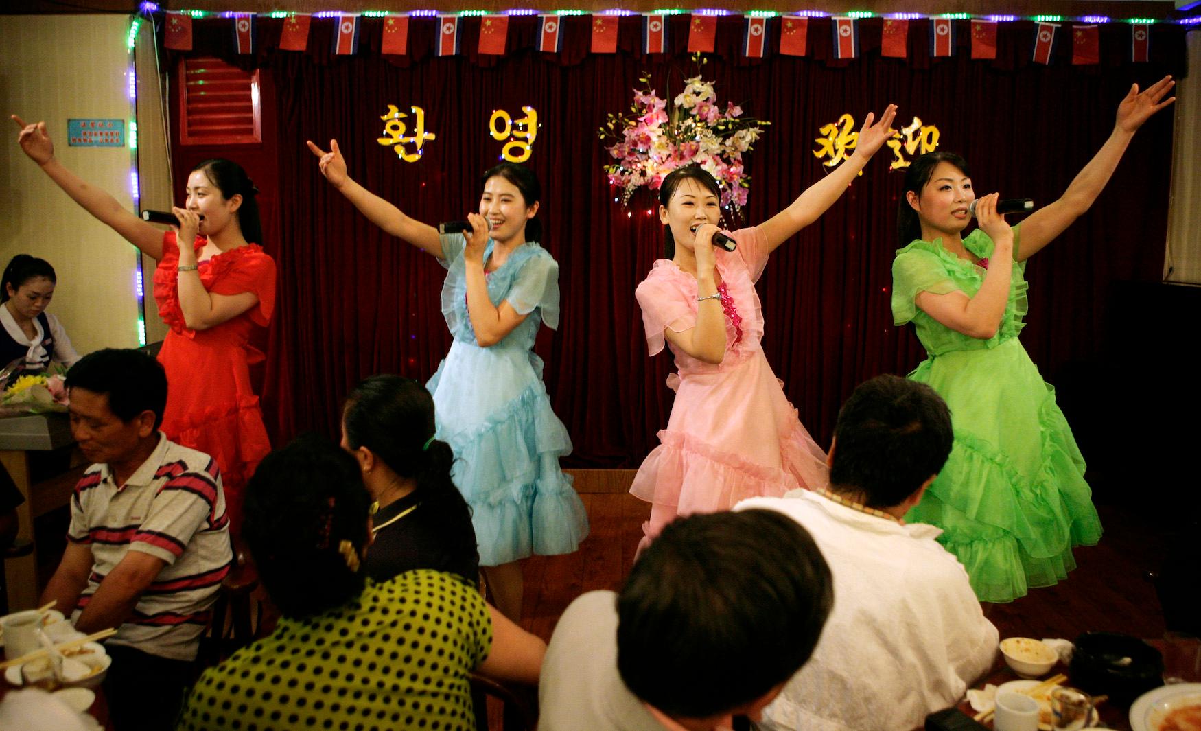 Singing waitresses entertain crowds at a North Korean restaurant in the Chinese border city of Dandong, on May 28, 2009.
