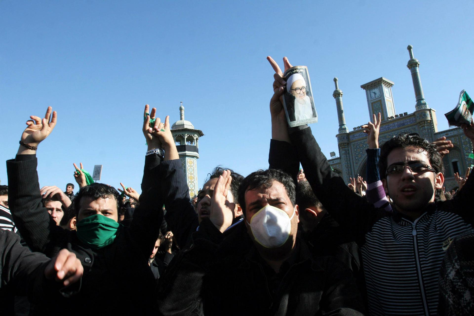 People wear green bands in support of the Iranian opposition movement during the funeral of dissident Iranian cleric Grand Ayatollah Hossein Ali Montazeri in the holy city of Qom on December 21, 2009.