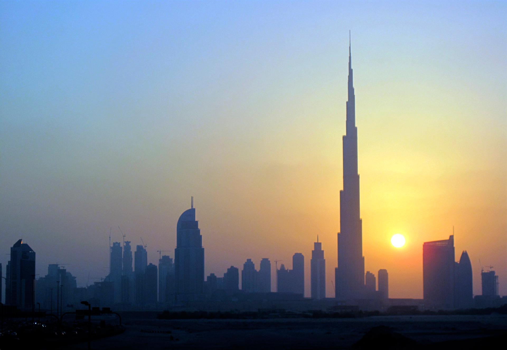 The Burj Khalifa (C) skyscraper is seen as the sun sets over Dubai on Oct. 5, 2010.