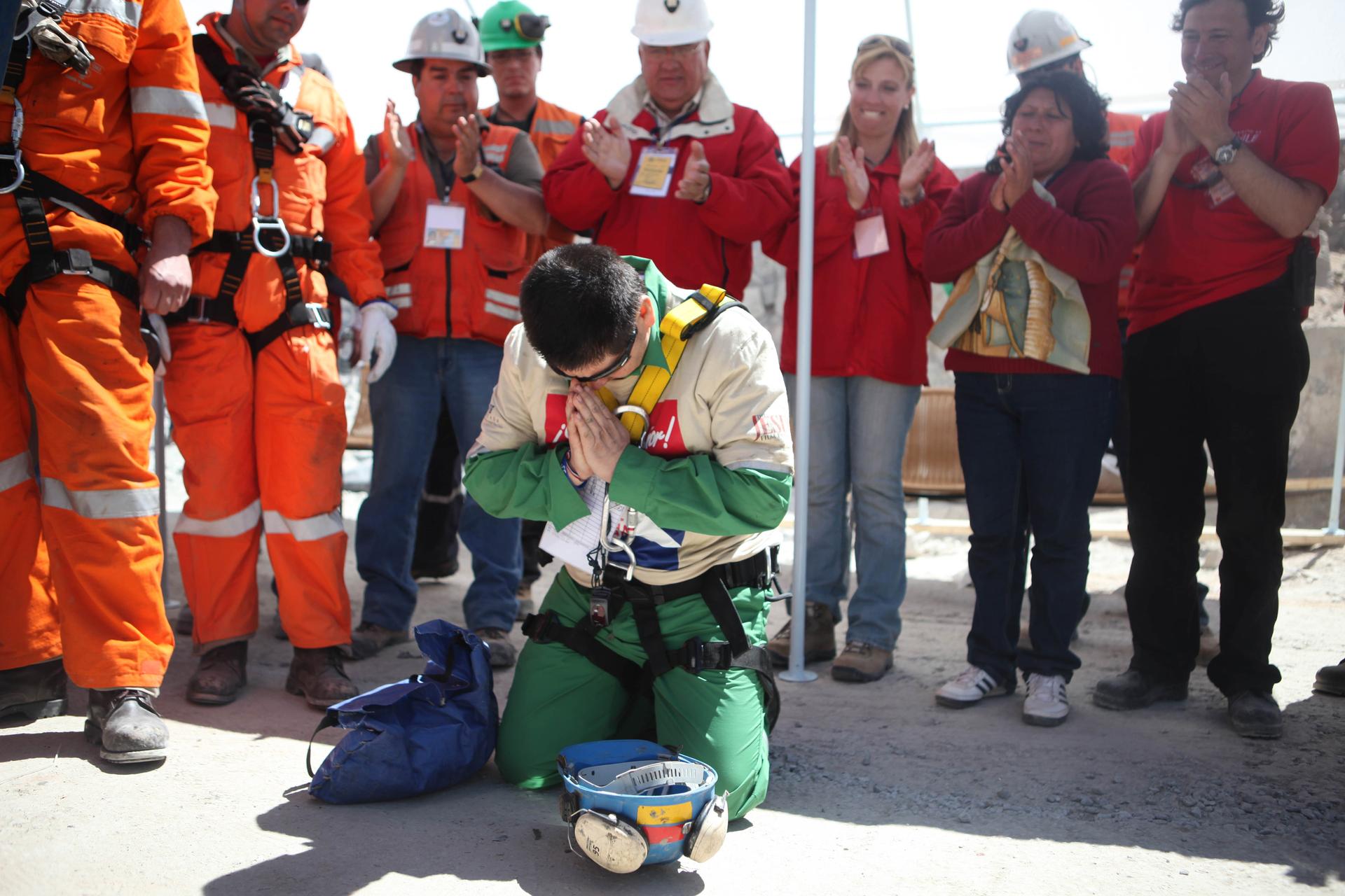 Trapped miner, Esteban Rojas, kneels to pray after being rescued from the San Jose mine in Copiapo, October 13th, 2010. 
