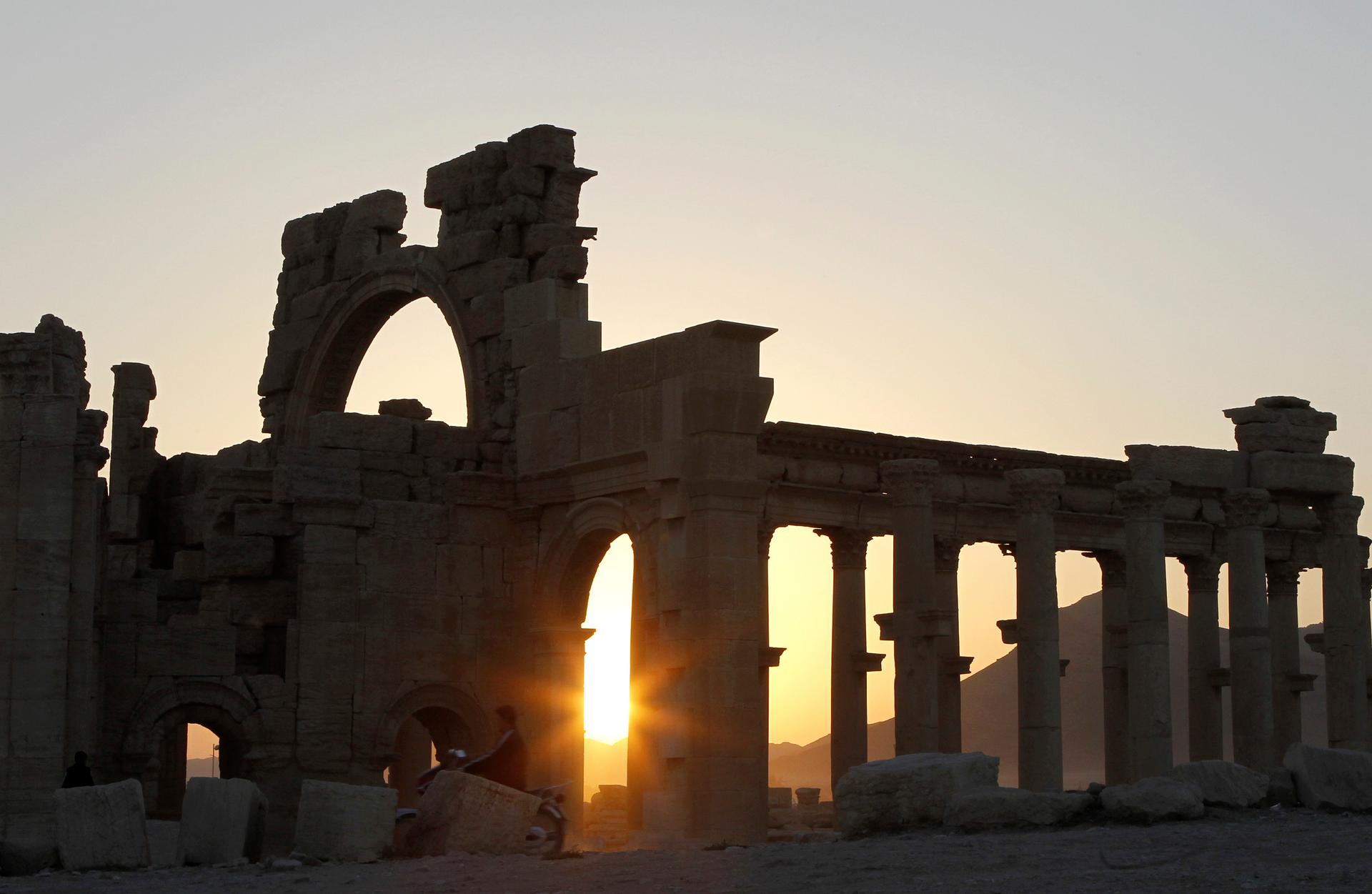 The sun sets behind ruined columns at the historical city of Palmyra, in the Syrian desert, some 240km (150 miles) northeast the capital of Damascus November 12, 2010.