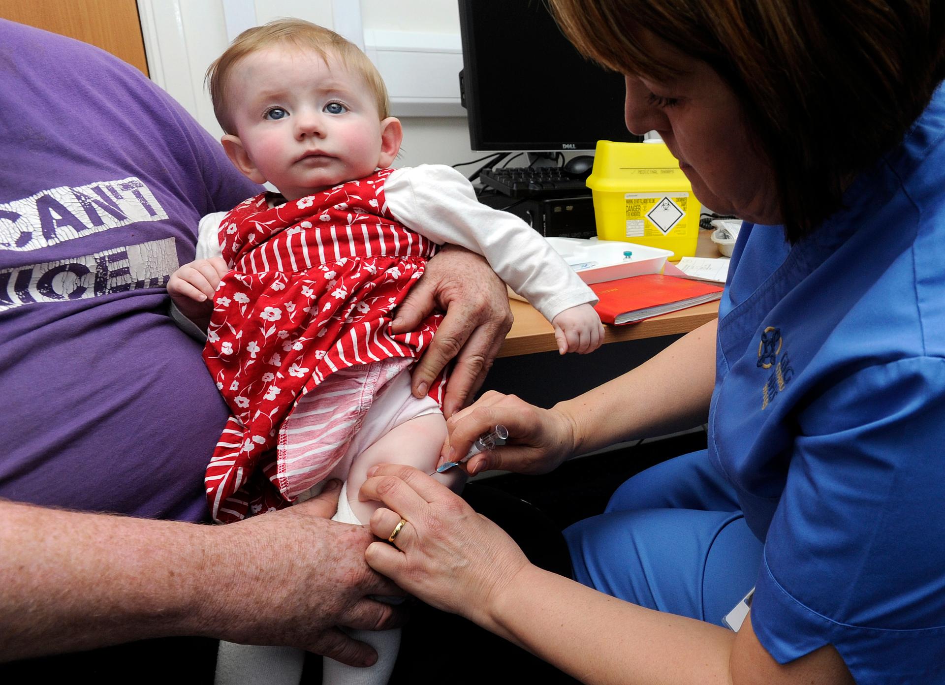 Ten-month old Lauren Durbin receives an injection for measles, mumps and rubella. Typically children do not receive the MMR vaccine until they are 12 months old. 