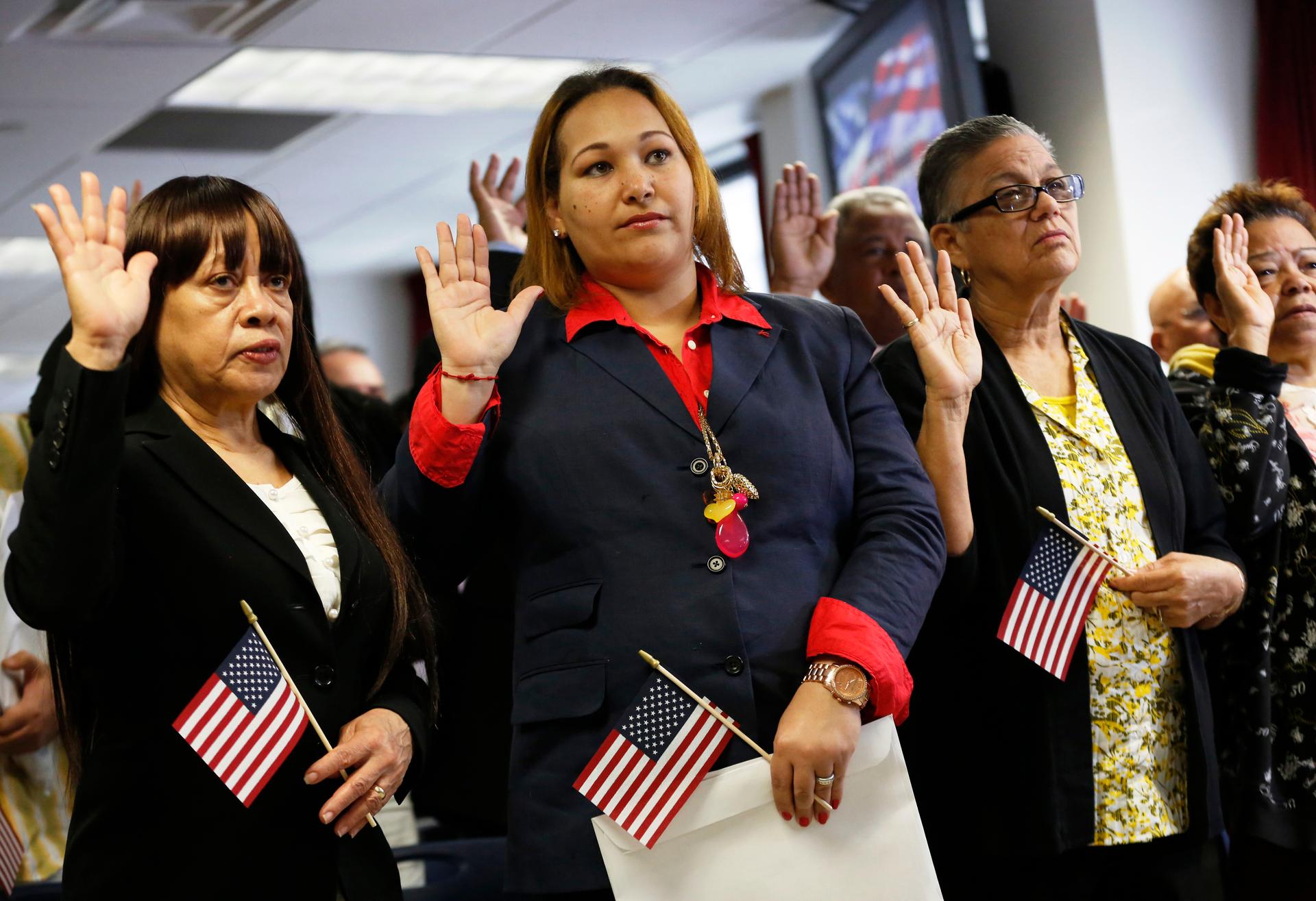 Immigrants take the oath of citizenship during a naturalization ceremony to become new citizens of the U.S. in New York.