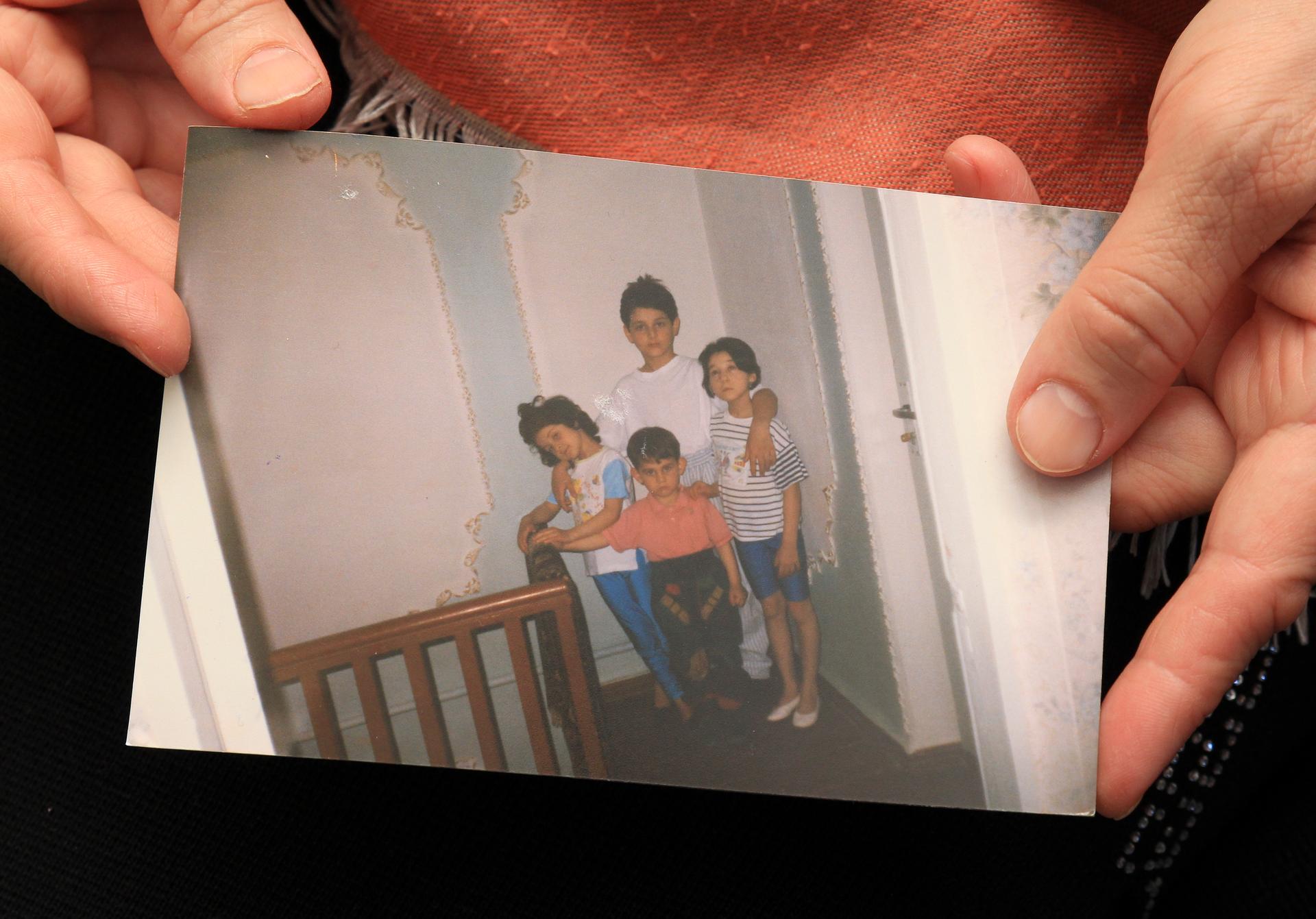 Patimat Suleimanova, aunt of Boston bombing suspects Dzhokhar and Tamerlan Tsarnaev, holds a photo from the family archive at her house in Makhachkala.