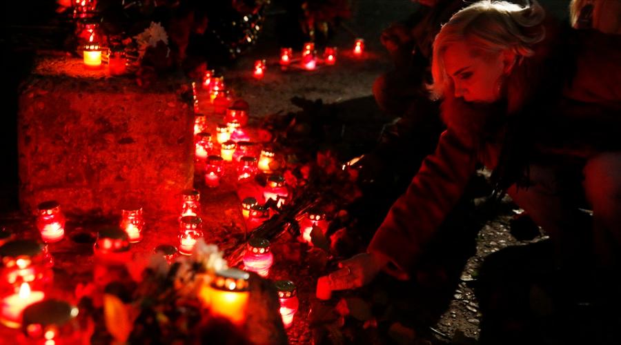 People place candles to honor passengers and crew members of a Russian military Tu-154 plane that crashed into the Black Sea on its way to Syria on Sunday, in the resort city of Sochi, Russia Dec. 25.