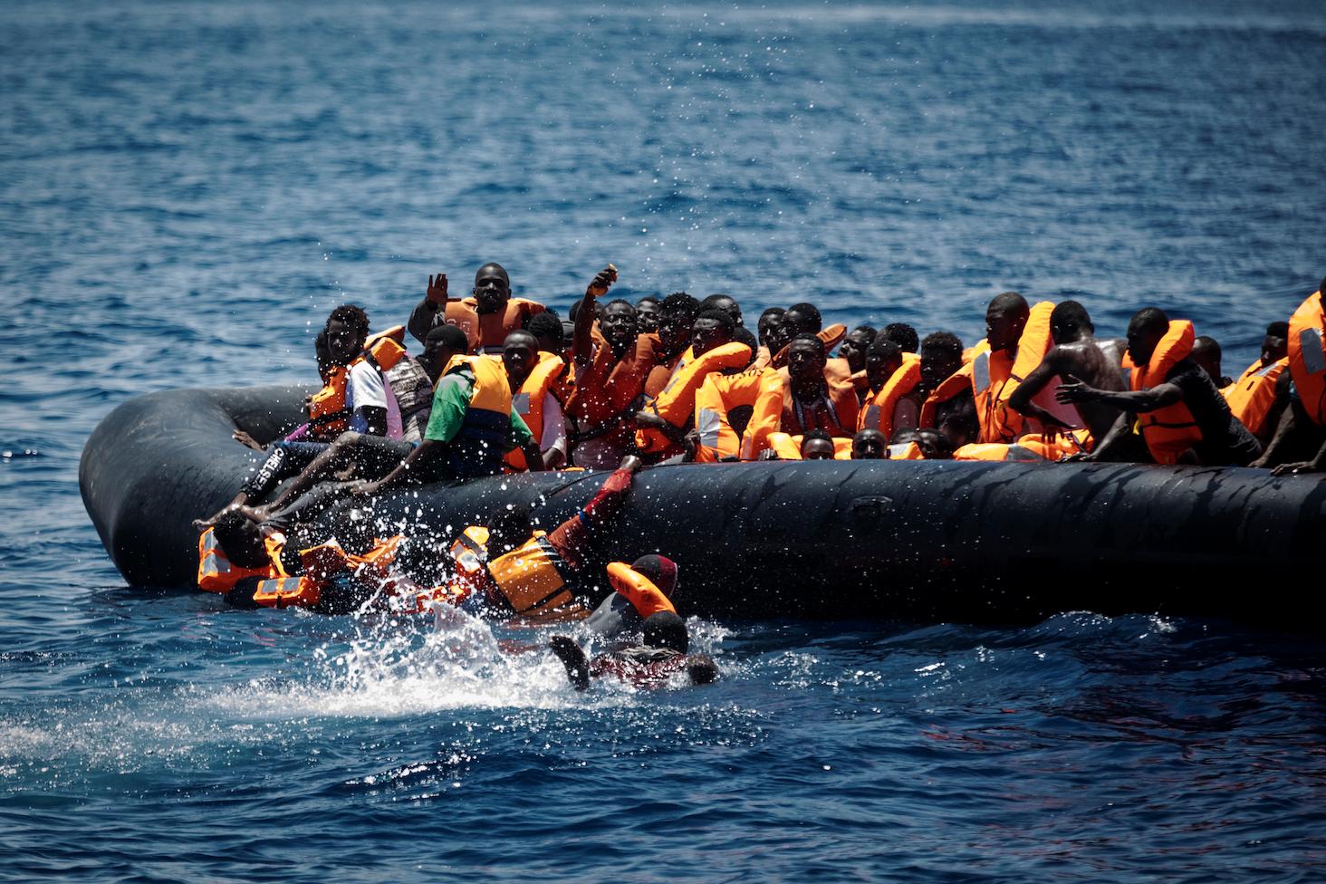 Migrants fall into the water during a rescue in the Mediterranean.