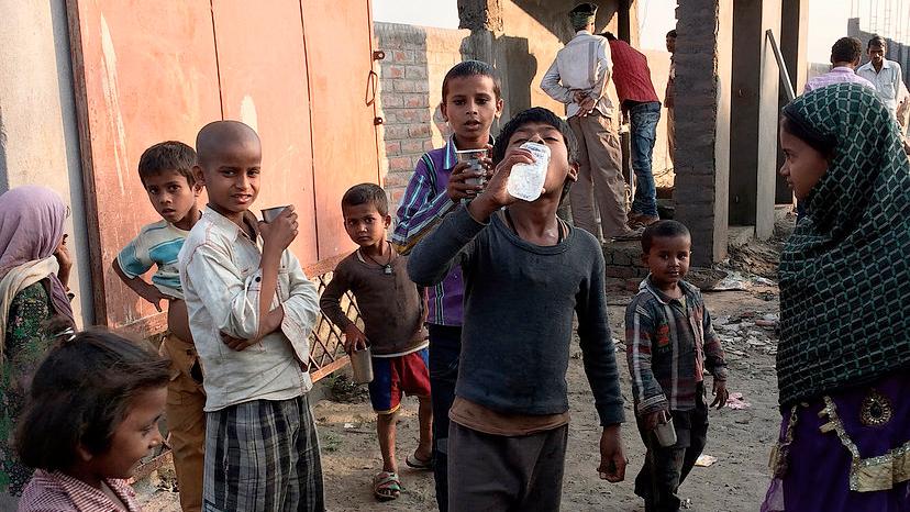Children drink water from the SHRI sanitation system.