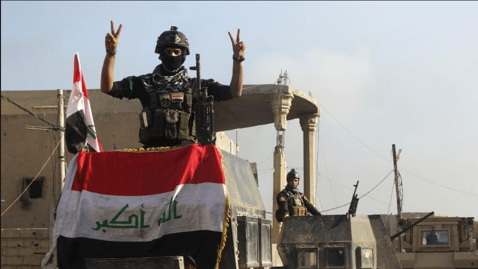 A member of the Iraqi security forces gestures at a government complex in the city of Ramadi, December 28, 2015. 