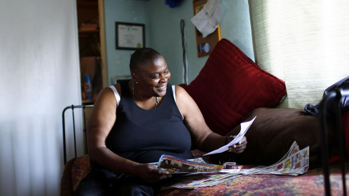 Mechille Johnson sits in her room at a group house of the reentry program A New Way of Life.
