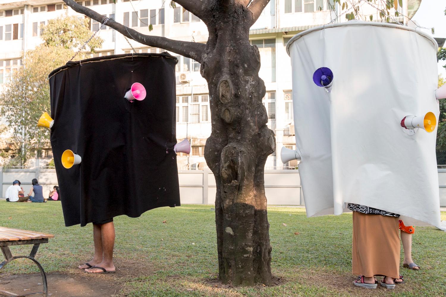 People in a Yangon try out the "soundsuit," an art installation that's designed to draw attention to noise. "Maybe once people hear what they sound like," says one of the creators, "they'll reduce the noise."