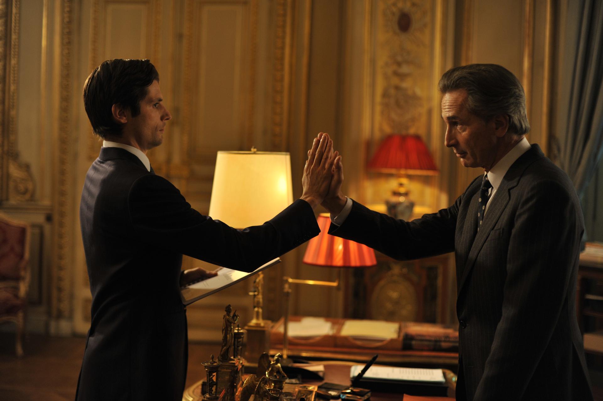 Speech writer Arthur Vlaminck (Raphaël Personnaz) tries to high-five French Foreign Minister Alexandre Taillard de Worms (Thierry Lhermitte) in Bertrand Tavernier’s new film, THE FRENCH MINISTER, a comedy based on the graphic novel "Weapons of Mass Diplom