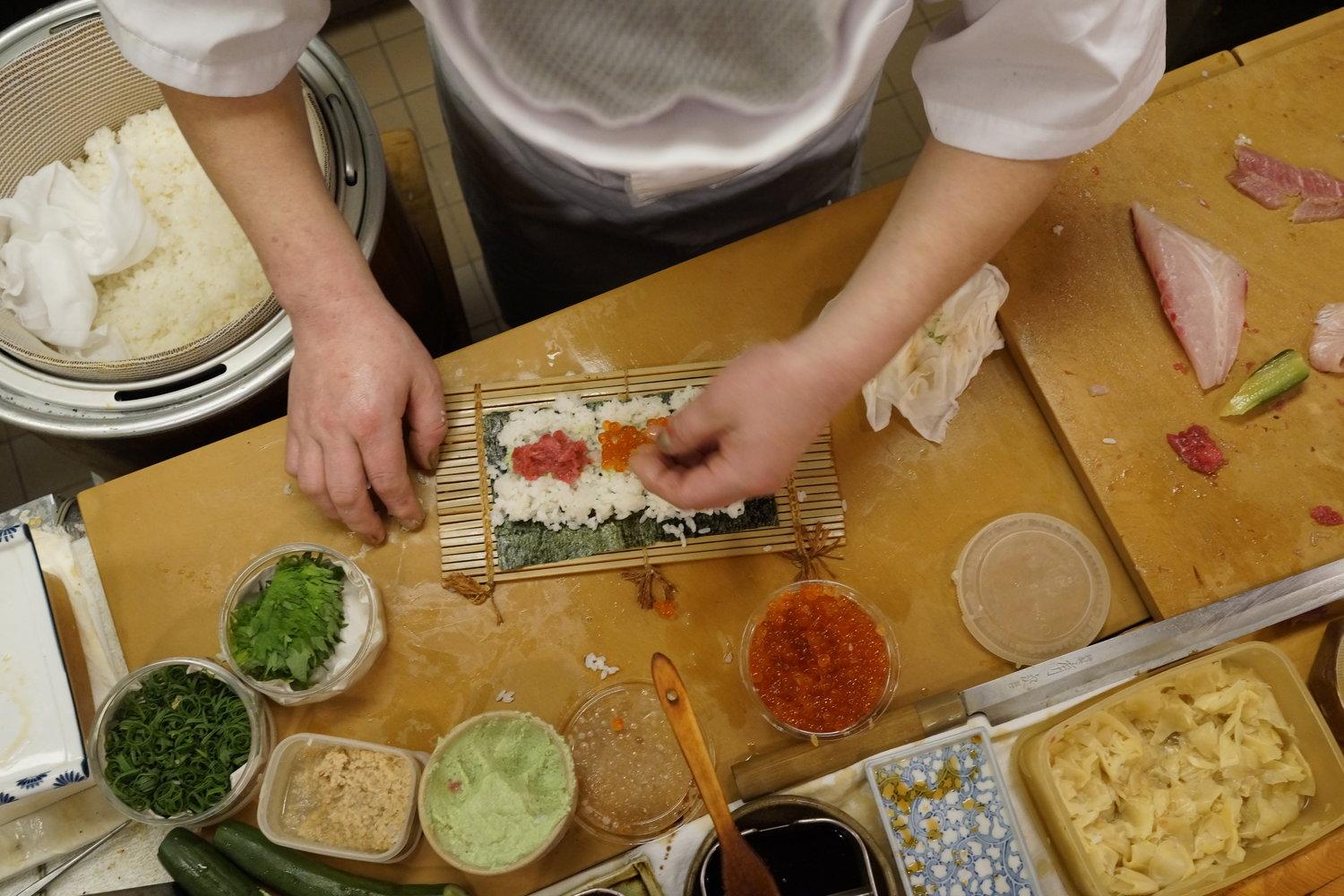 Chef Susumu Yajima carefully forms a delicious roll of sushi